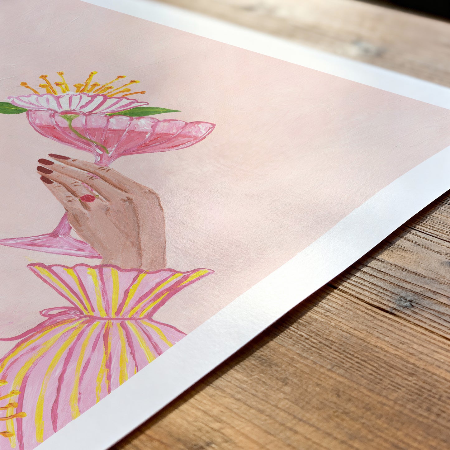 Illustration of a hand holding a pink flower on a wooden surface
