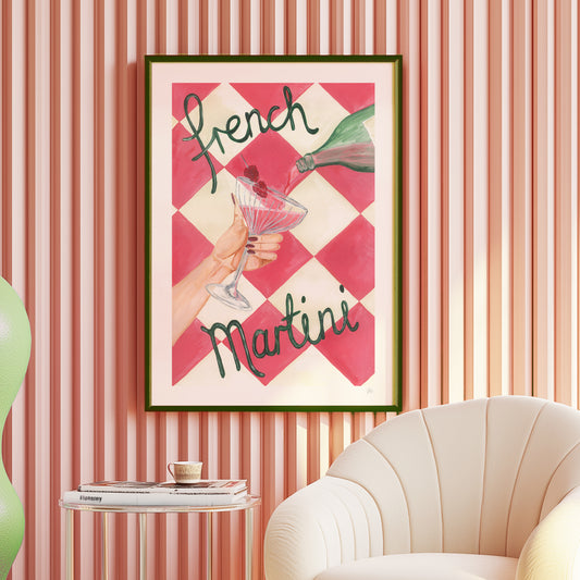 Framed artwork with 'French Martini' text on a checkered background, displayed in a room with striped walls and a chair.