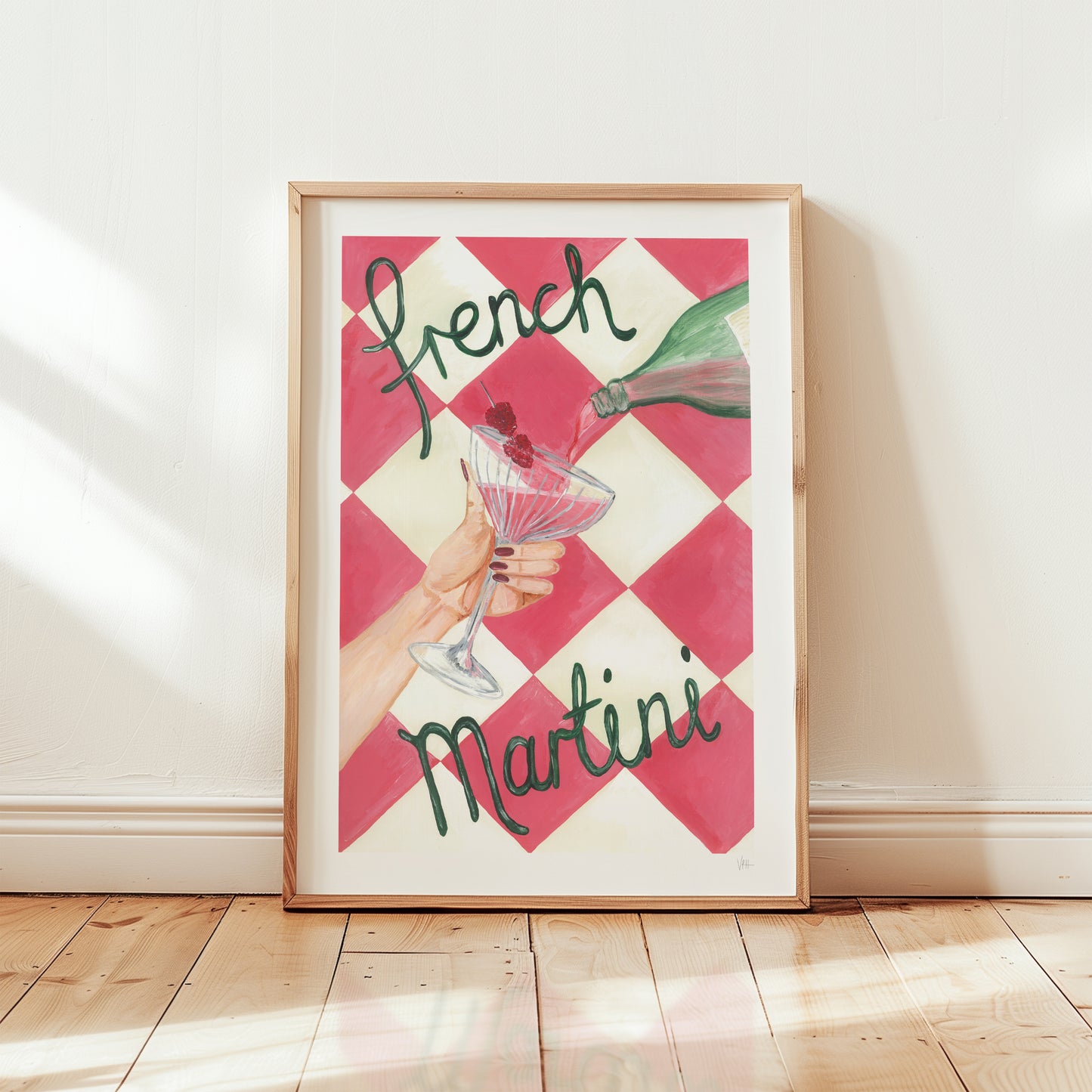 Framed artwork with 'French Martini' text and a checkered pattern on a wall.