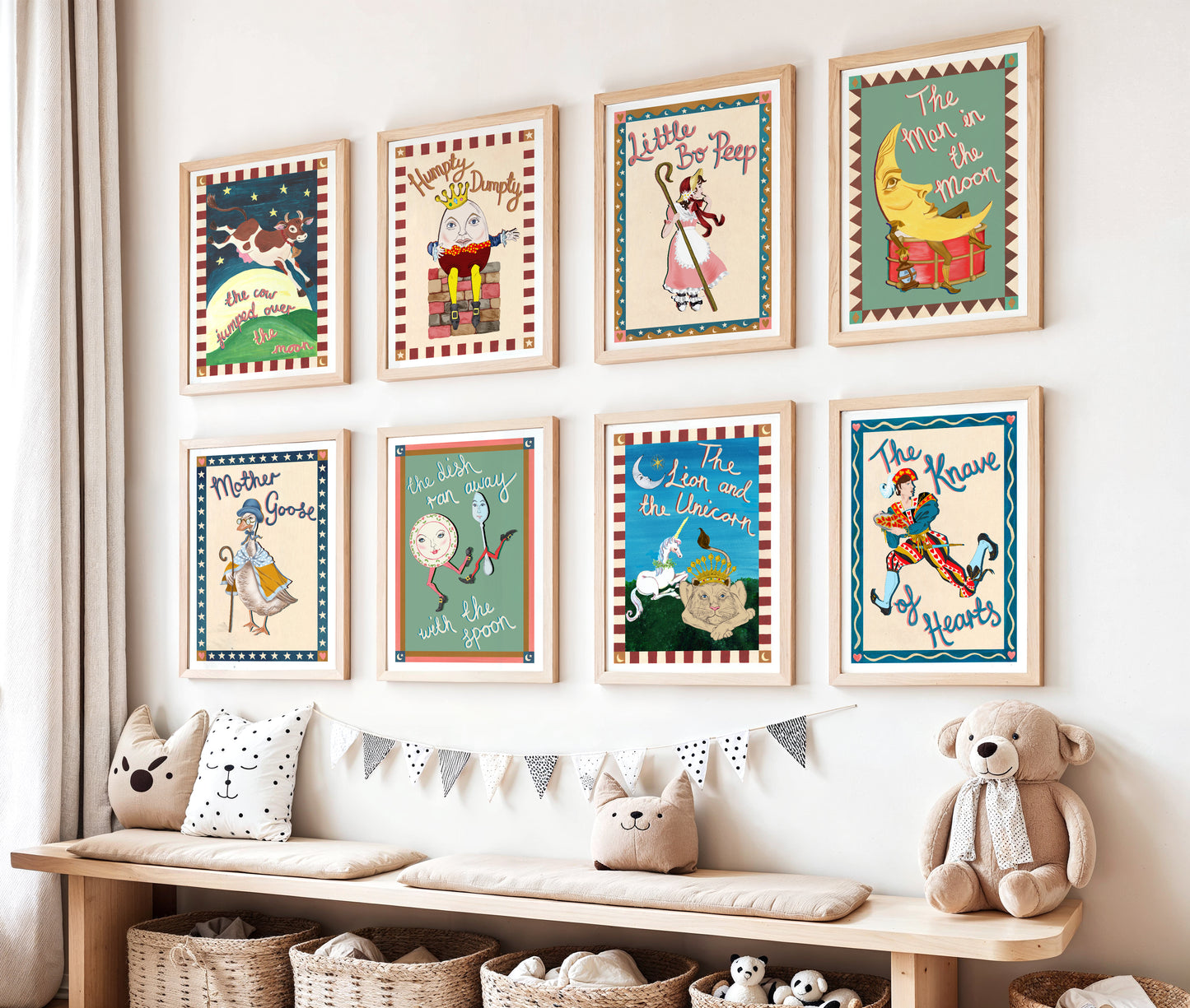 Children's room with framed illustrations on the wall and a bench with toys and pillows.