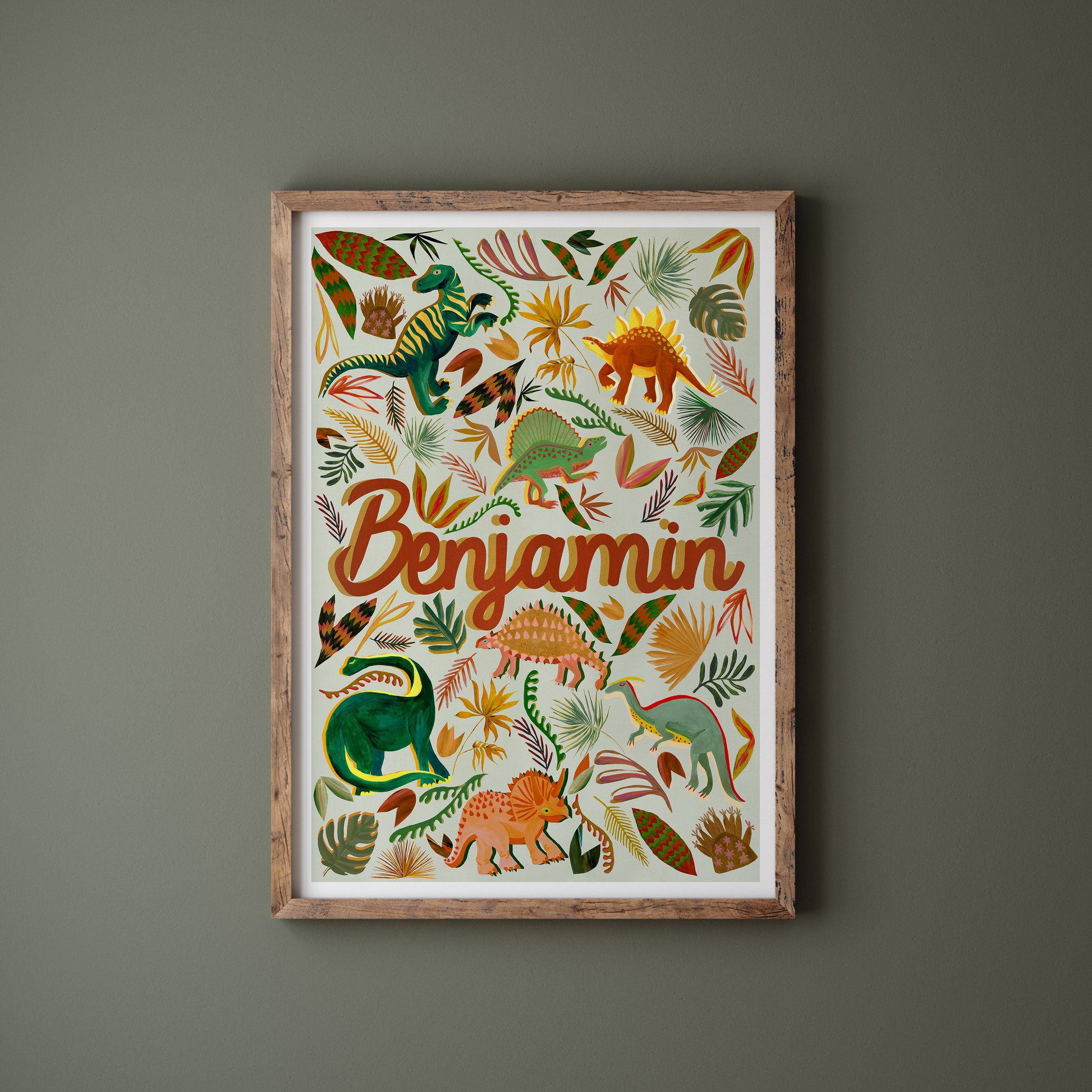 Framed children's poster with dinosaur illustrations and the name 'Benjamin' on a dark gray background