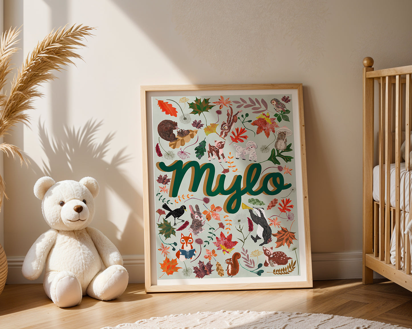 Framed artwork with 'Mylo' surrounded by colorful illustrations in a nursery setting.