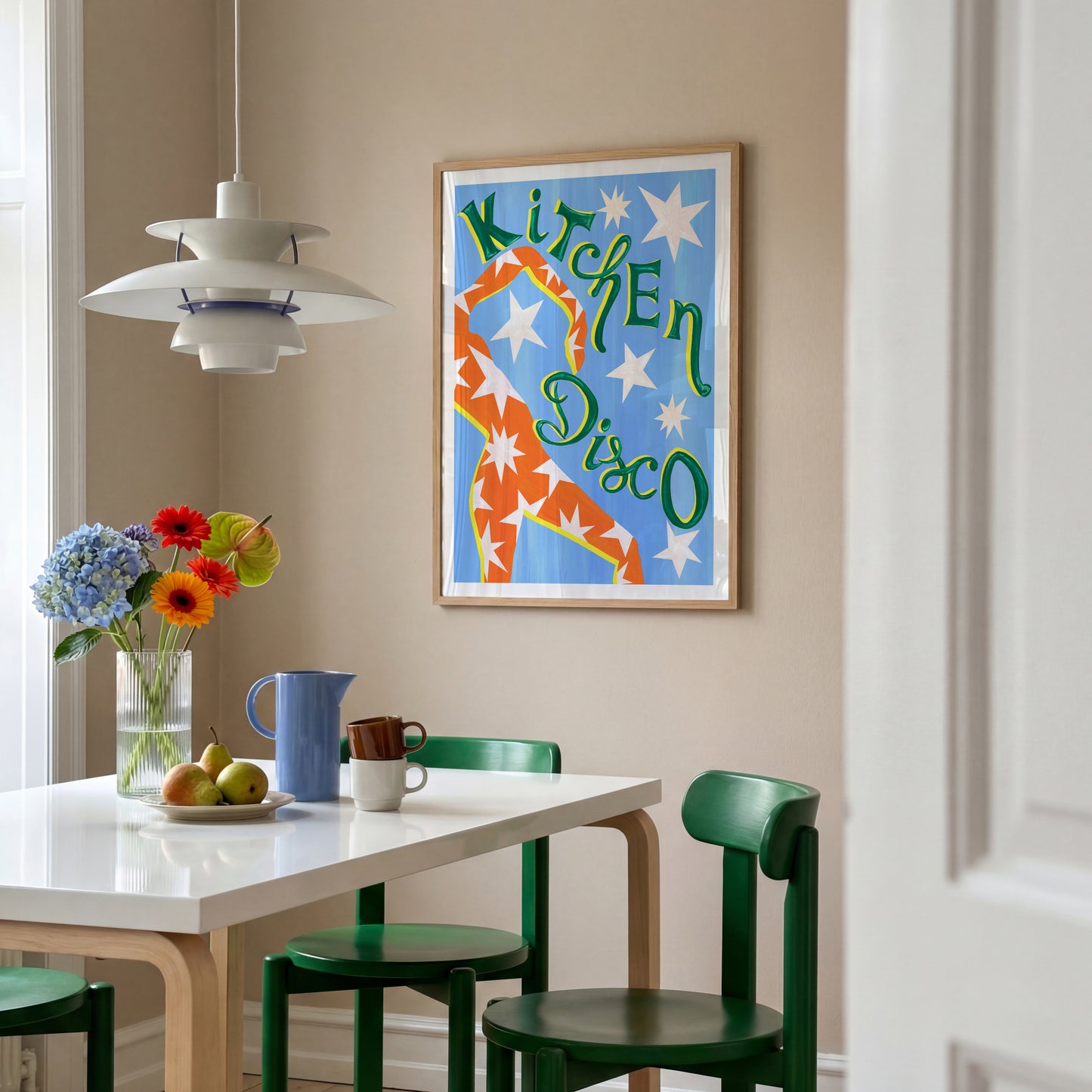 Dining room with a table, chairs, and a colorful 'Kitchen Disco' poster on the wall.