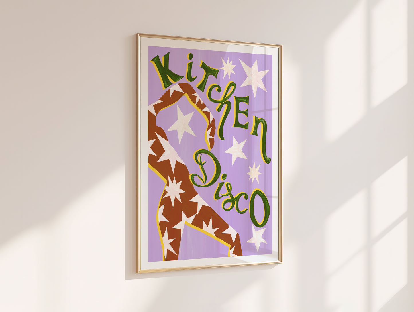 Framed artwork with 'Kitchen Disco' text and a dancer design on a purple background, mounted on a white wall.