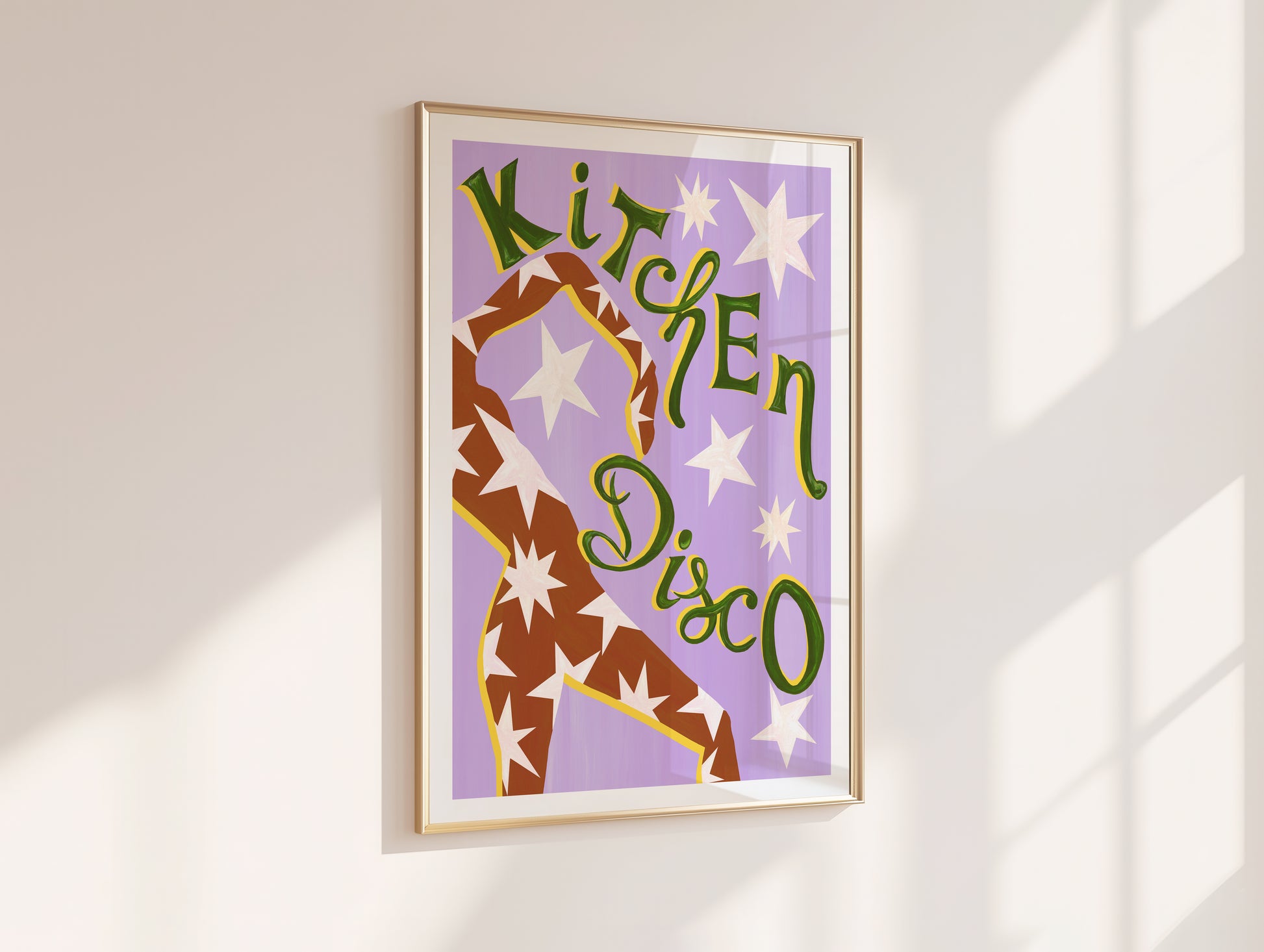 Framed artwork with 'Kitchen Disco' text and a dancer design on a purple background, mounted on a white wall.