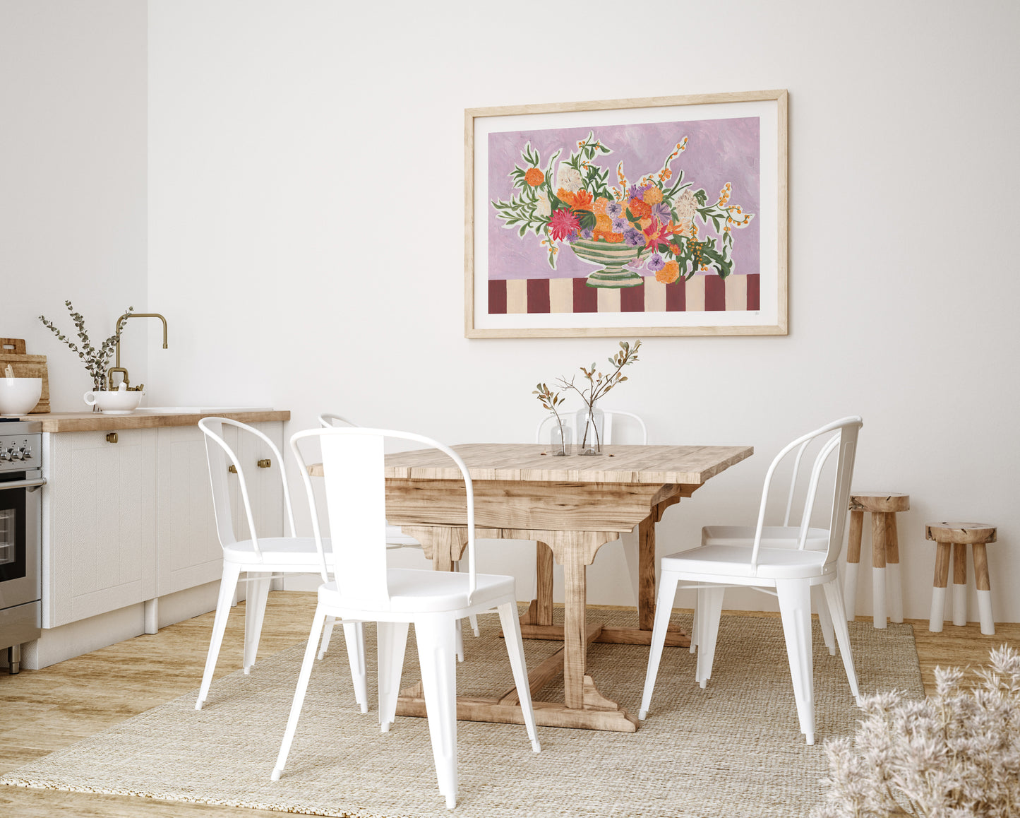 Dining room with wooden table and white chairs, framed artwork on the wall.
