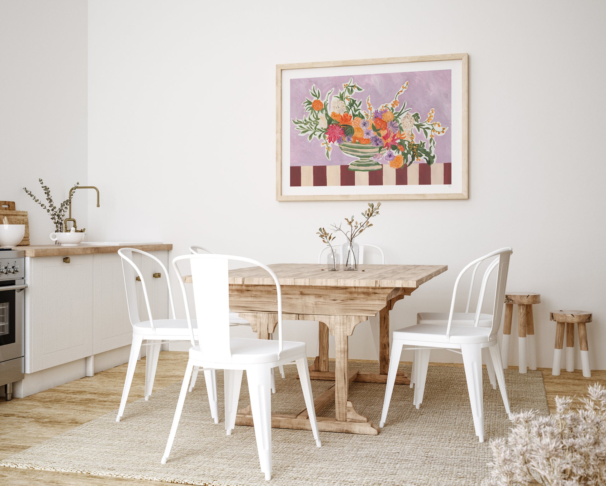 Dining room with wooden table and white chairs, framed artwork on the wall.