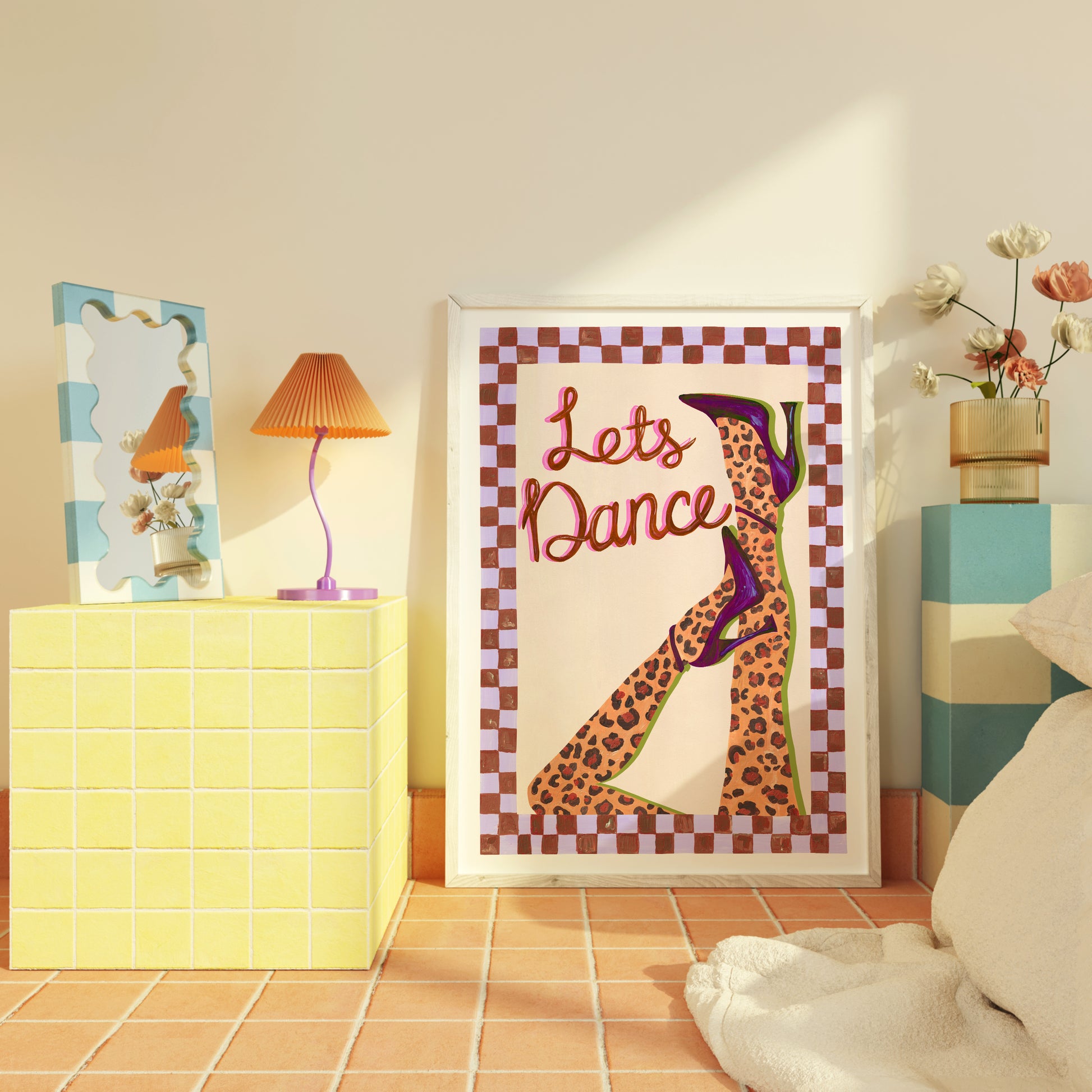 Framed artwork with 'Let's Dance' text and leopard print design in a room setting.