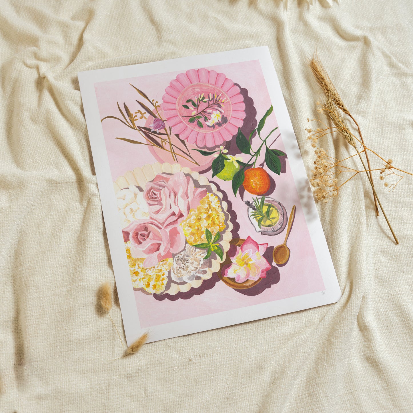 Floral illustration on a pink background with dried plants on a beige fabric surface