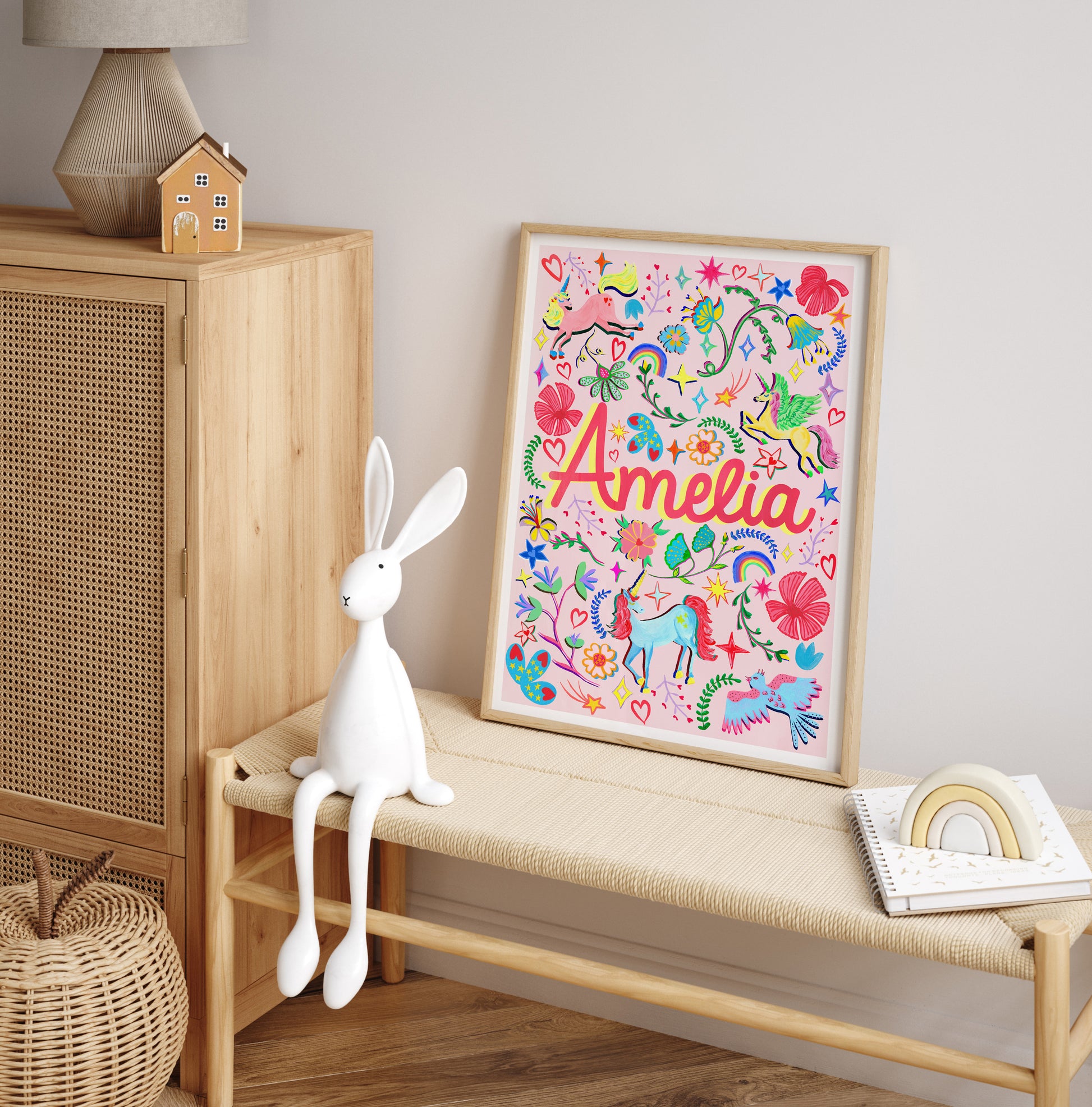 Children's room with a colorful framed artwork, white rabbit toy, and wooden cabinet.