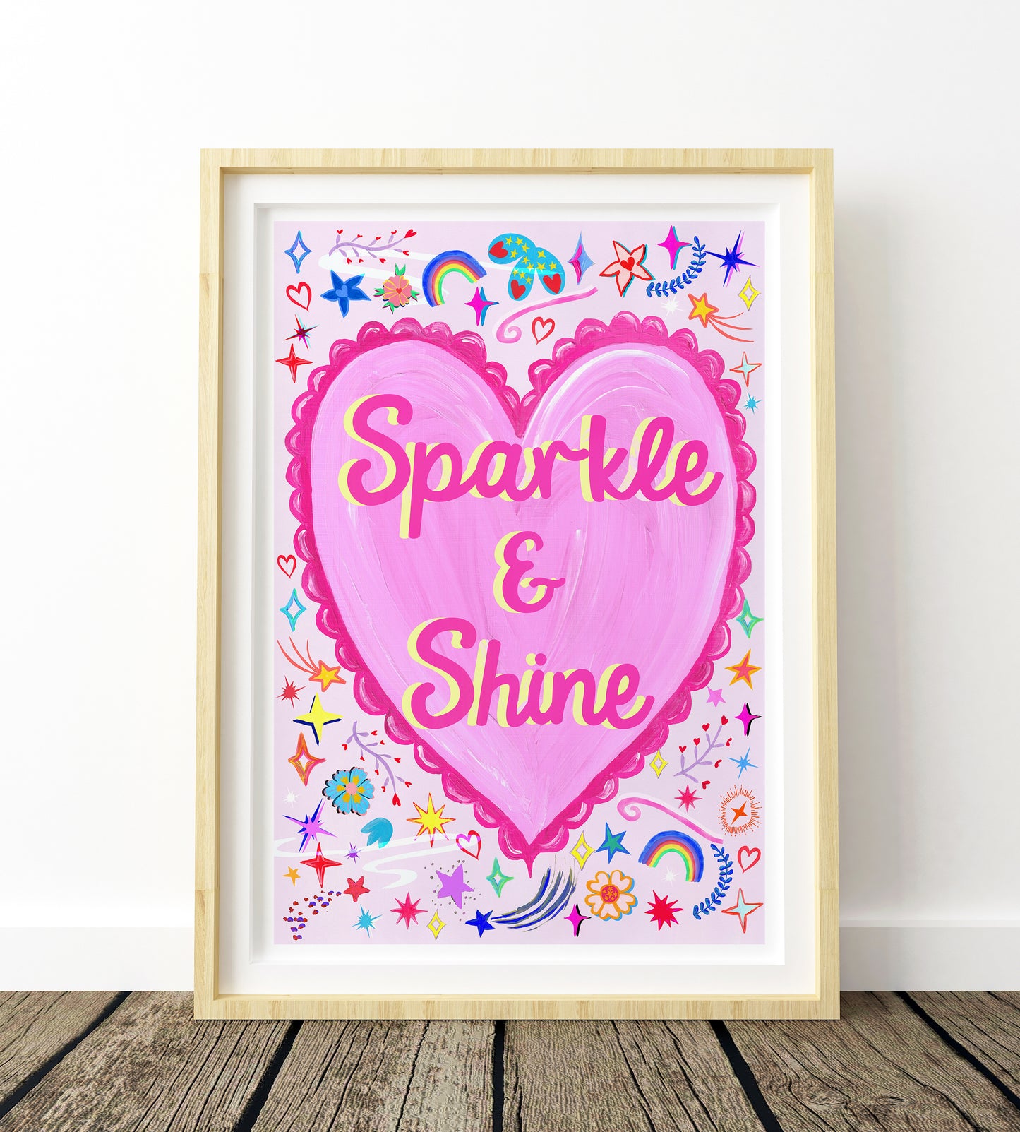 Framed artwork with a pink heart and 'Sparkle & Shine' text on a white background.