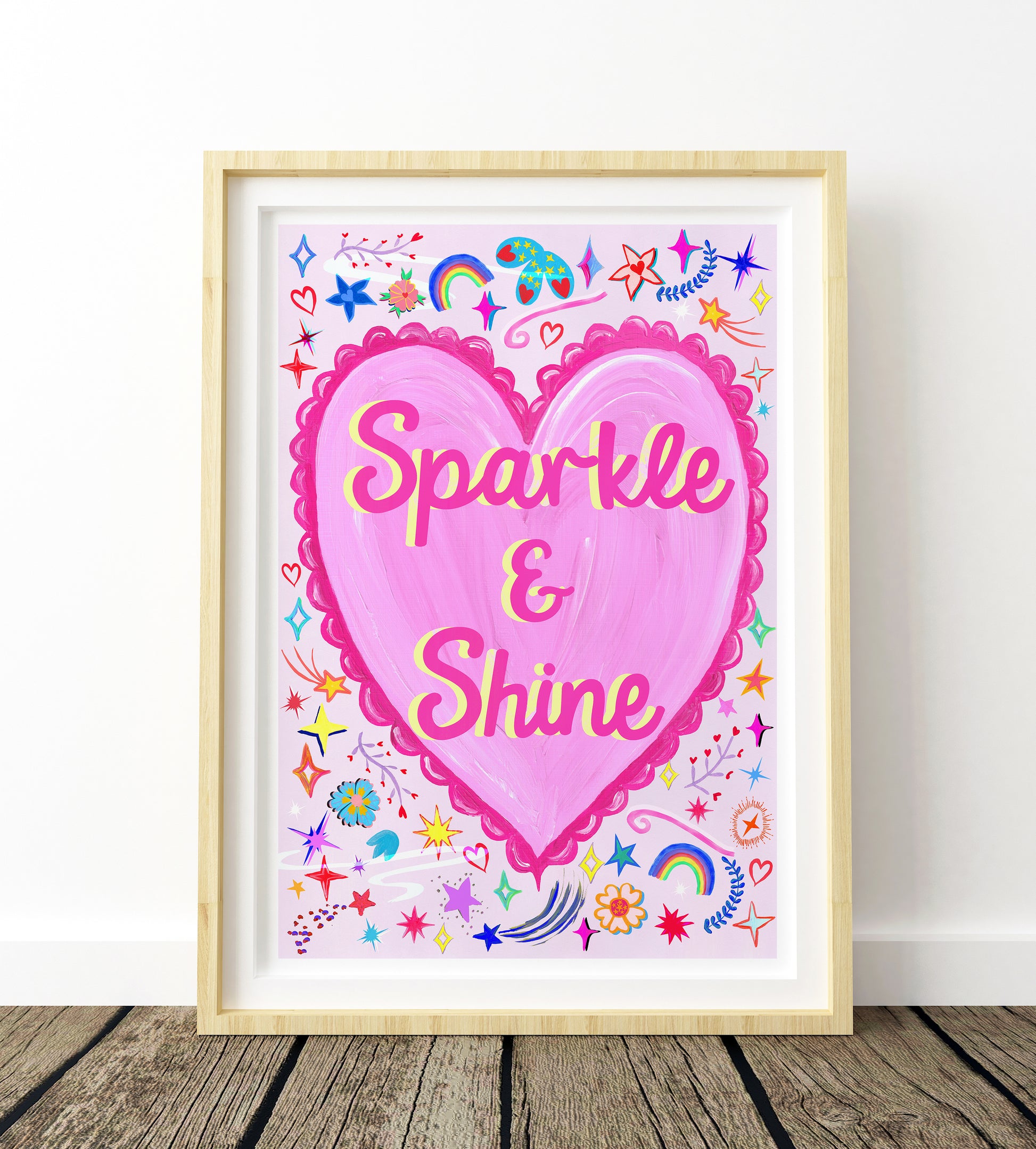 Framed artwork with a pink heart and 'Sparkle & Shine' text on a white background.