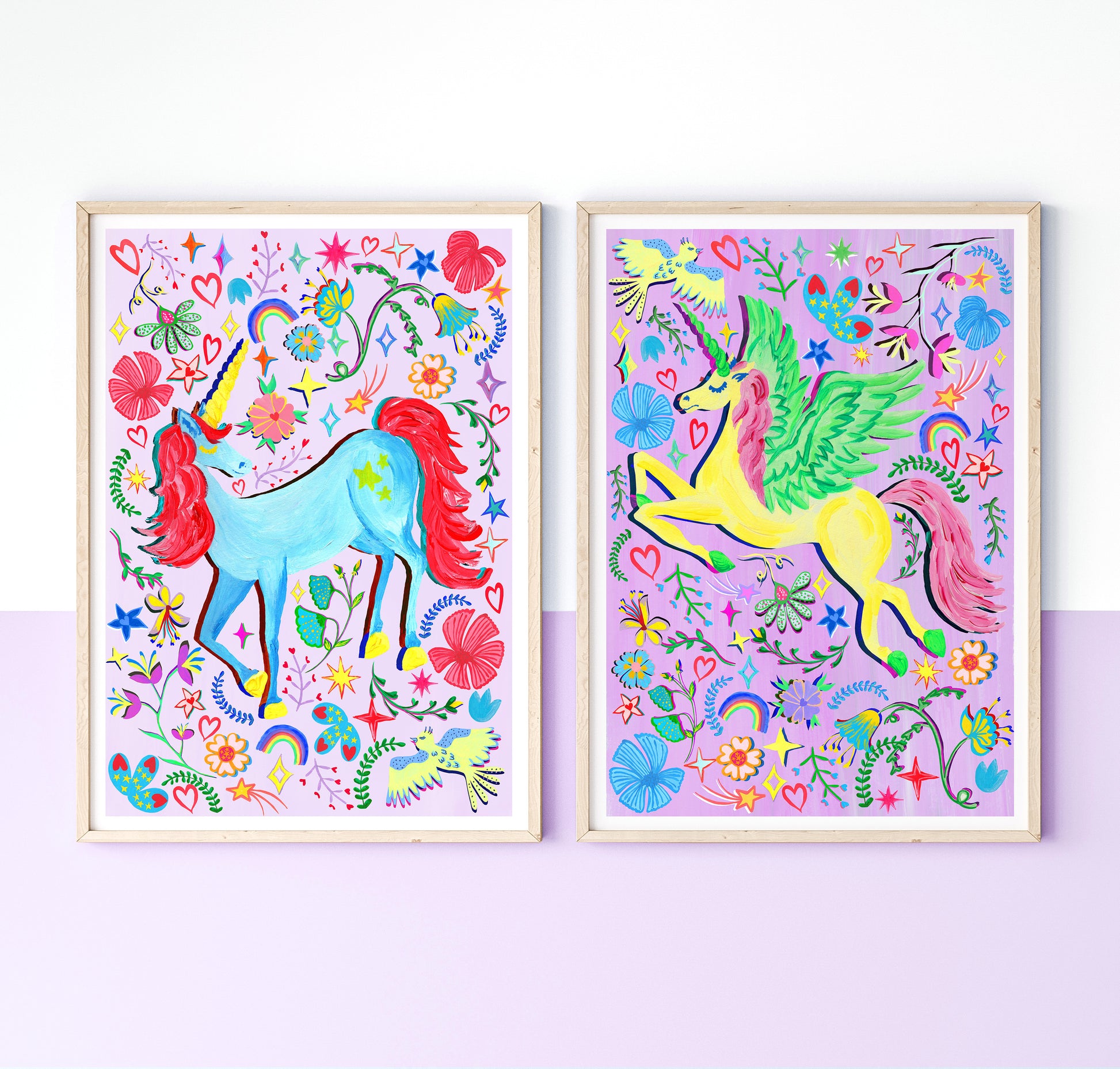 A set of 2 colourful Unicorn prints on lilac and purple background surrounded by colourful flower and rainbow illustrations, placed in light wood frames on a white and liac wall.