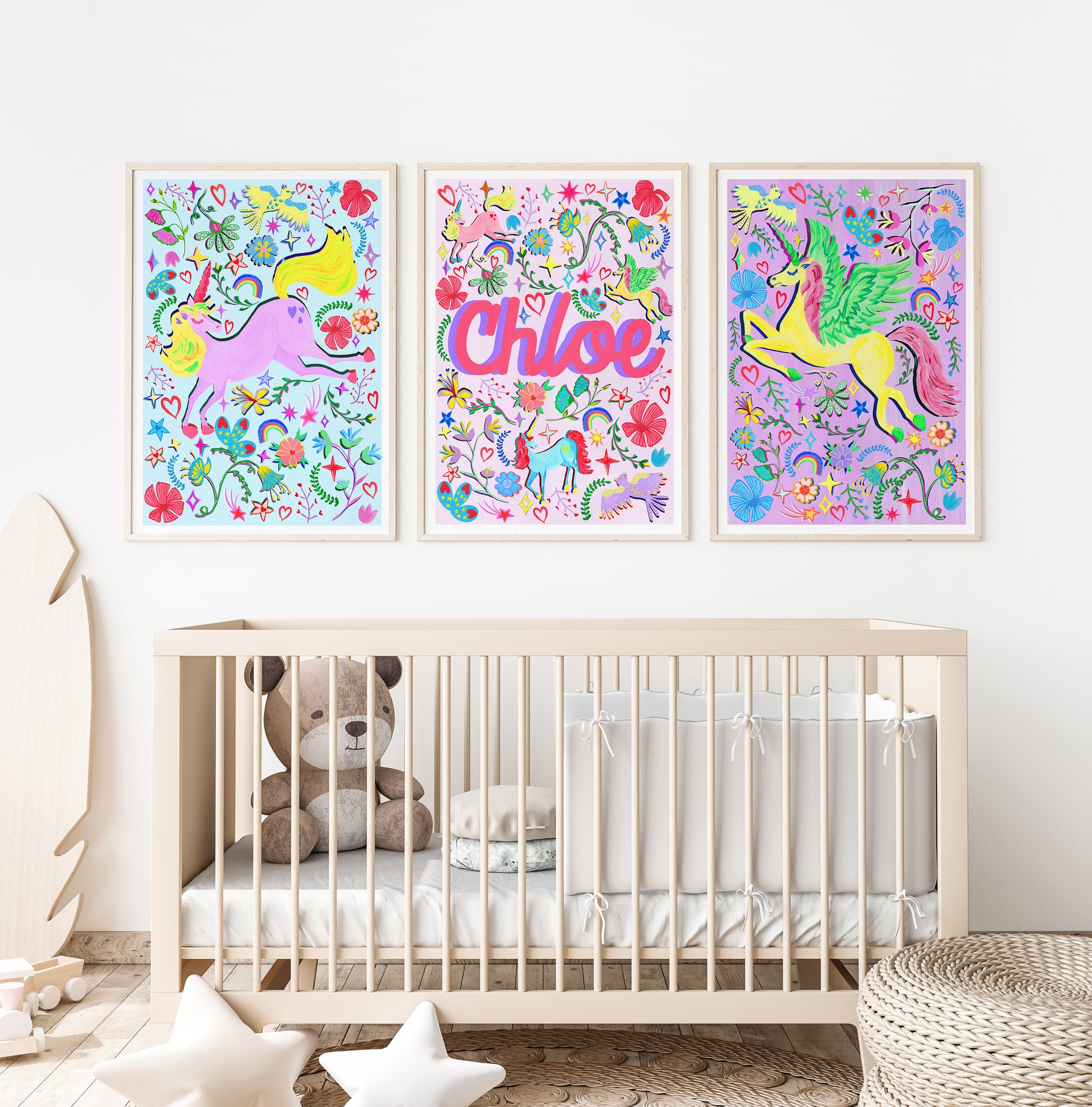 A nursery bedroom with 3 unicorn prints place above a cot.