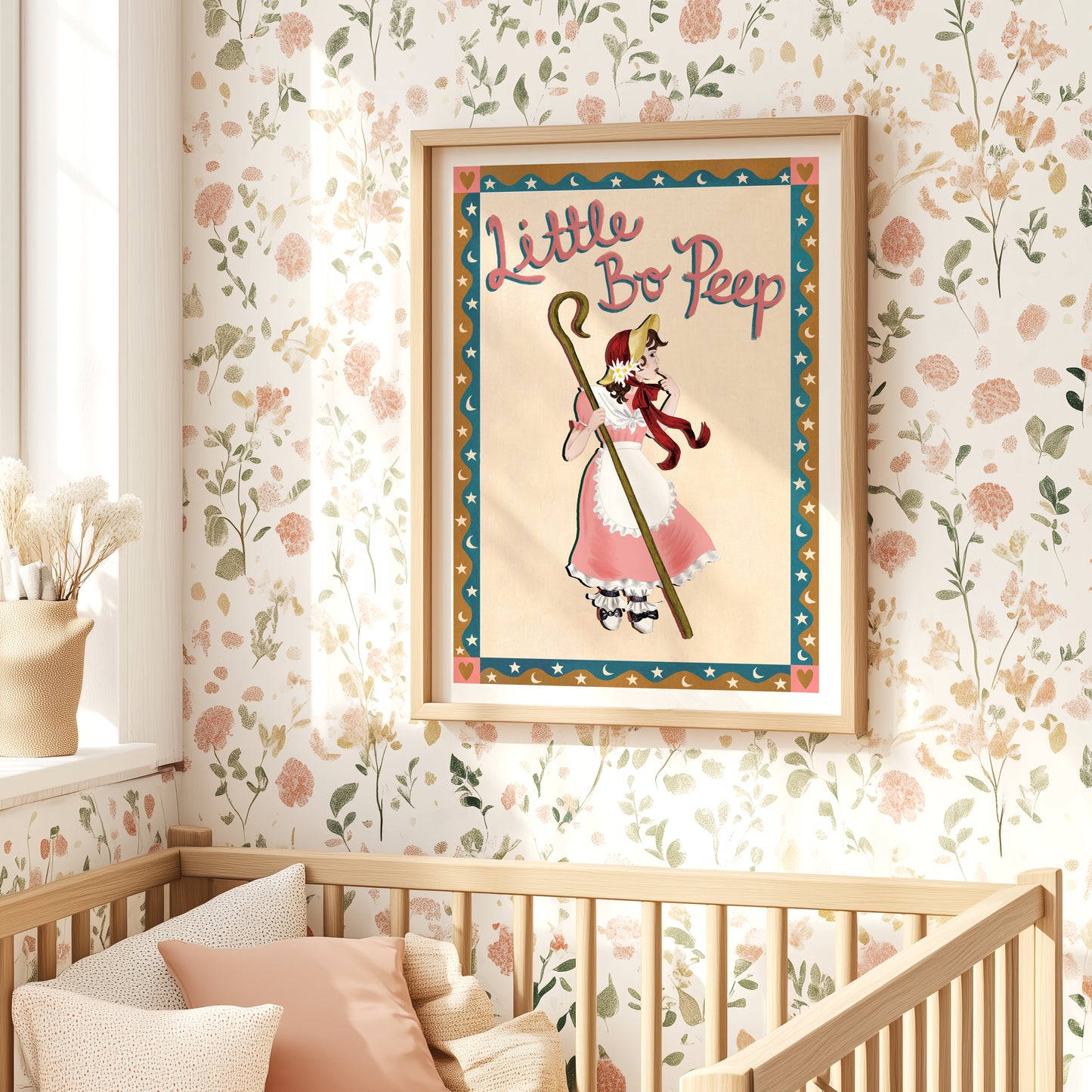 Framed 'Little Bo Peep' poster in a nursery with floral wallpaper and wooden crib.