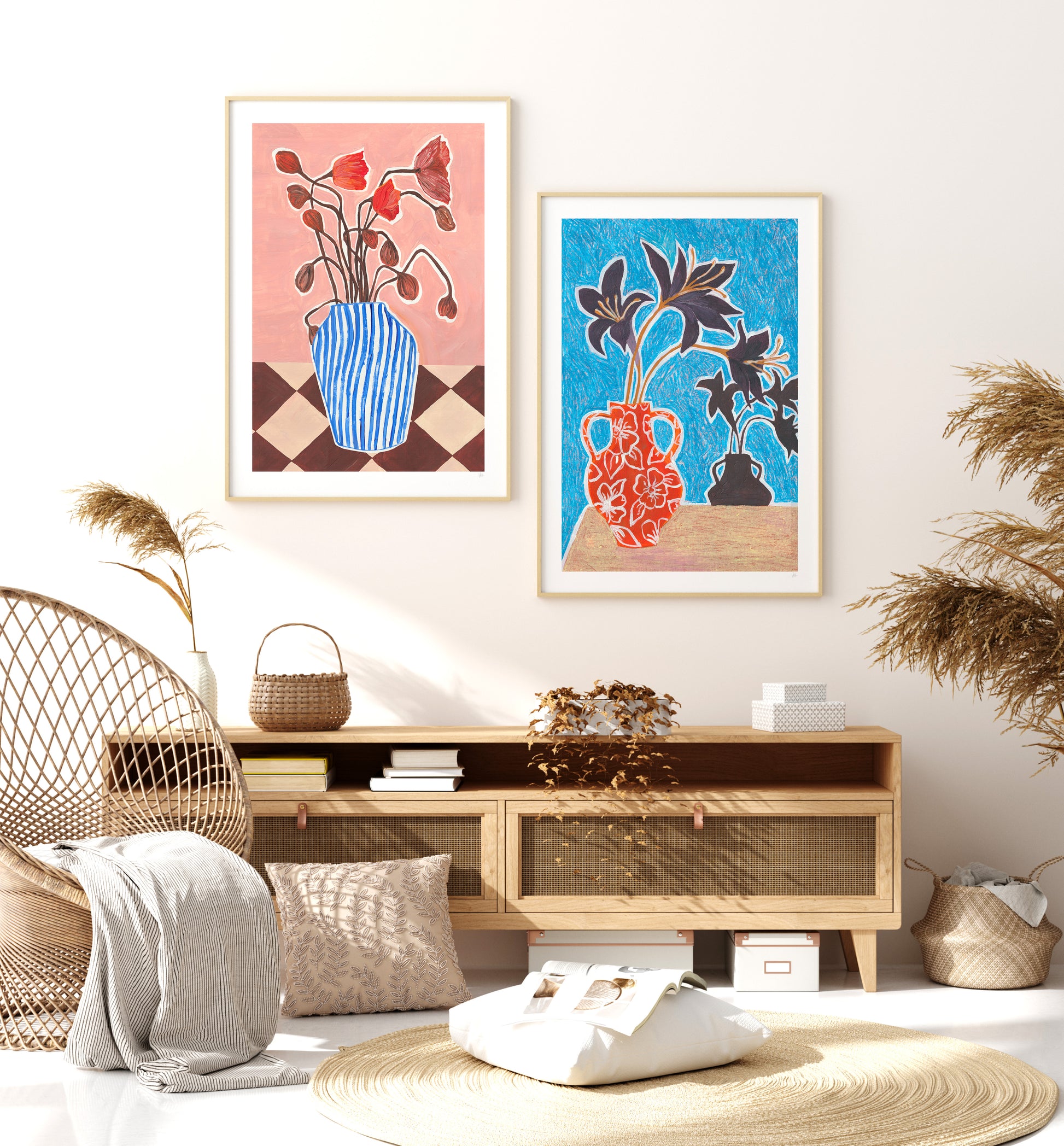 Living room with wooden TV stand, decorative pillows, and framed botanical still life artworks on a white wall.