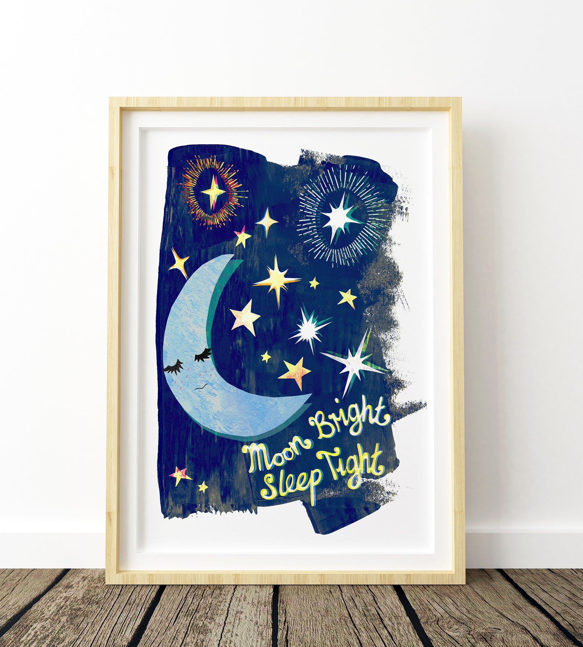 Framed artwork with a moon and star design on a white wall.