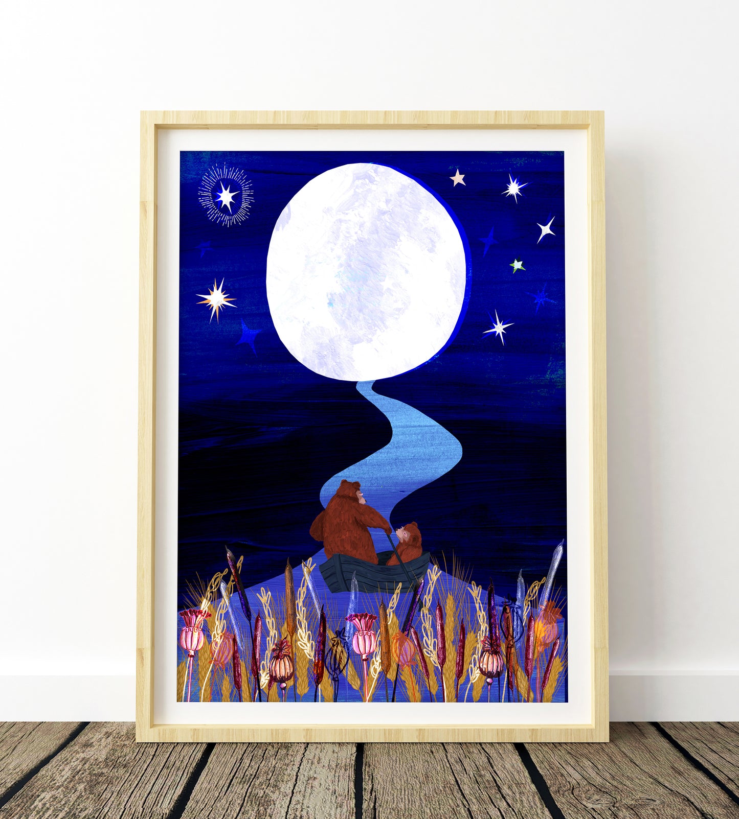 Framed artwork of a bear sitting under a full moon with stars on a blue night sky.
