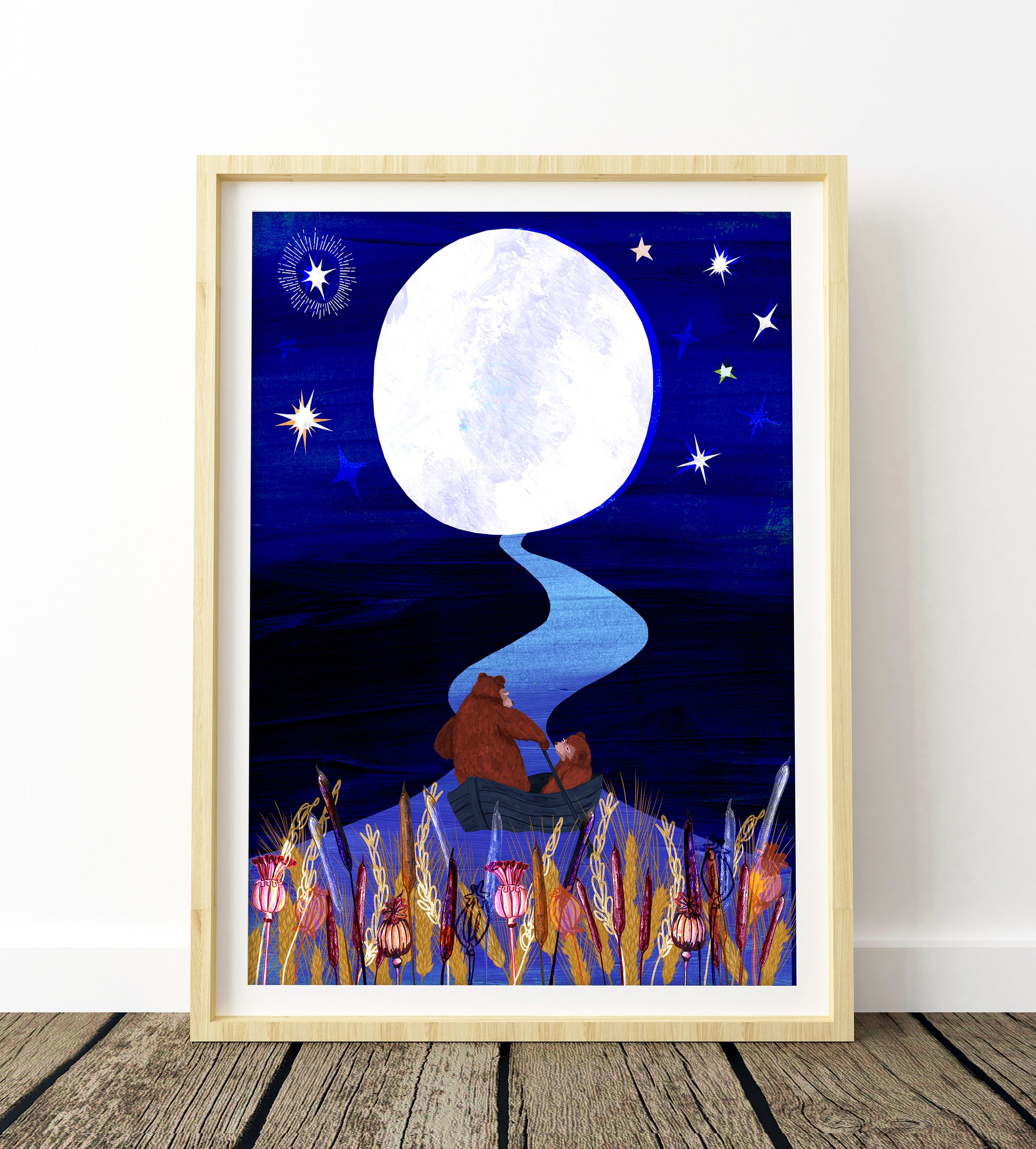 Framed artwork of a bear sitting under a full moon with stars on a blue night sky.