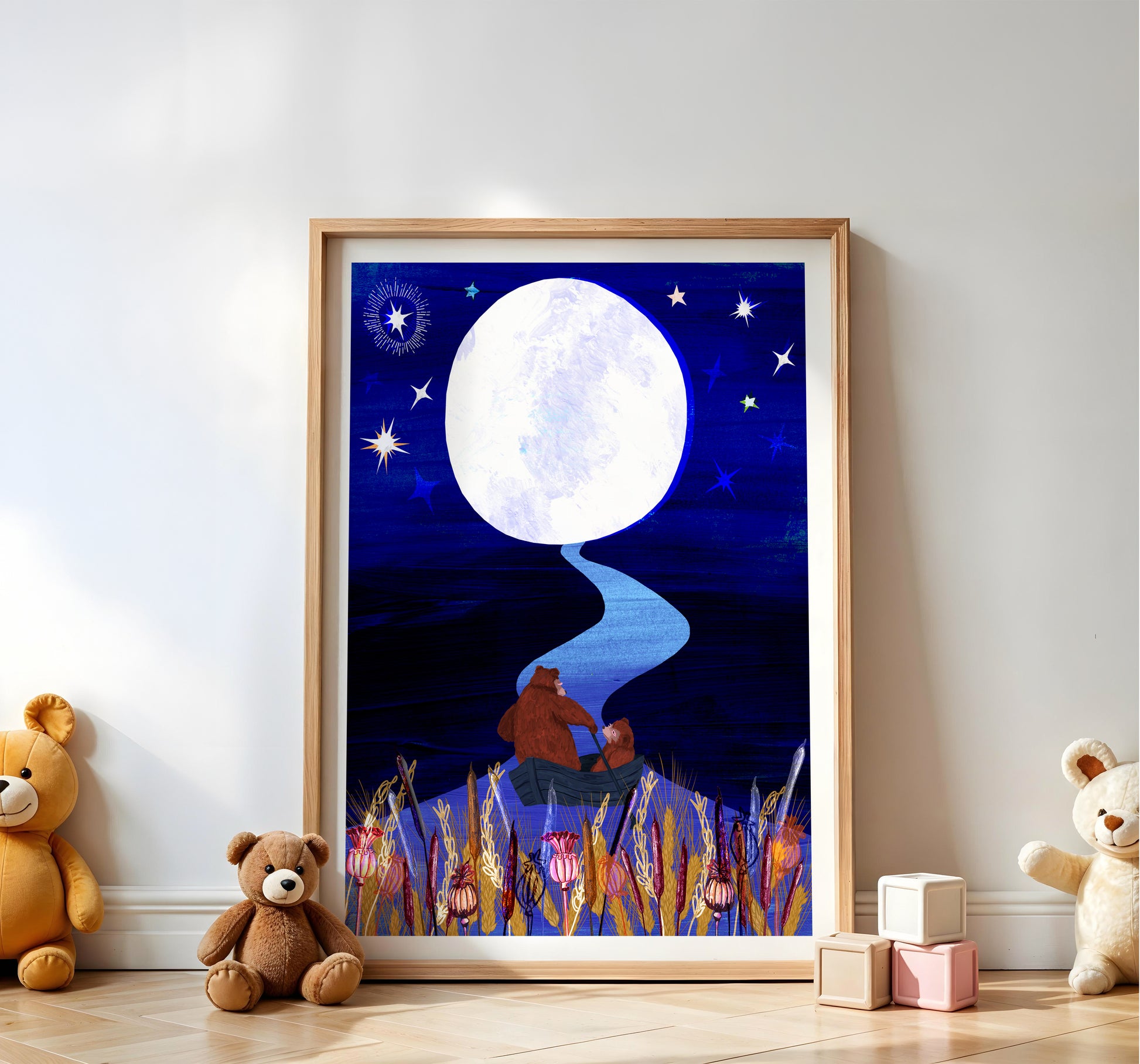 Framed artwork of a bear and child under a moonlit sky, with teddy bears and blocks on a wooden floor.
