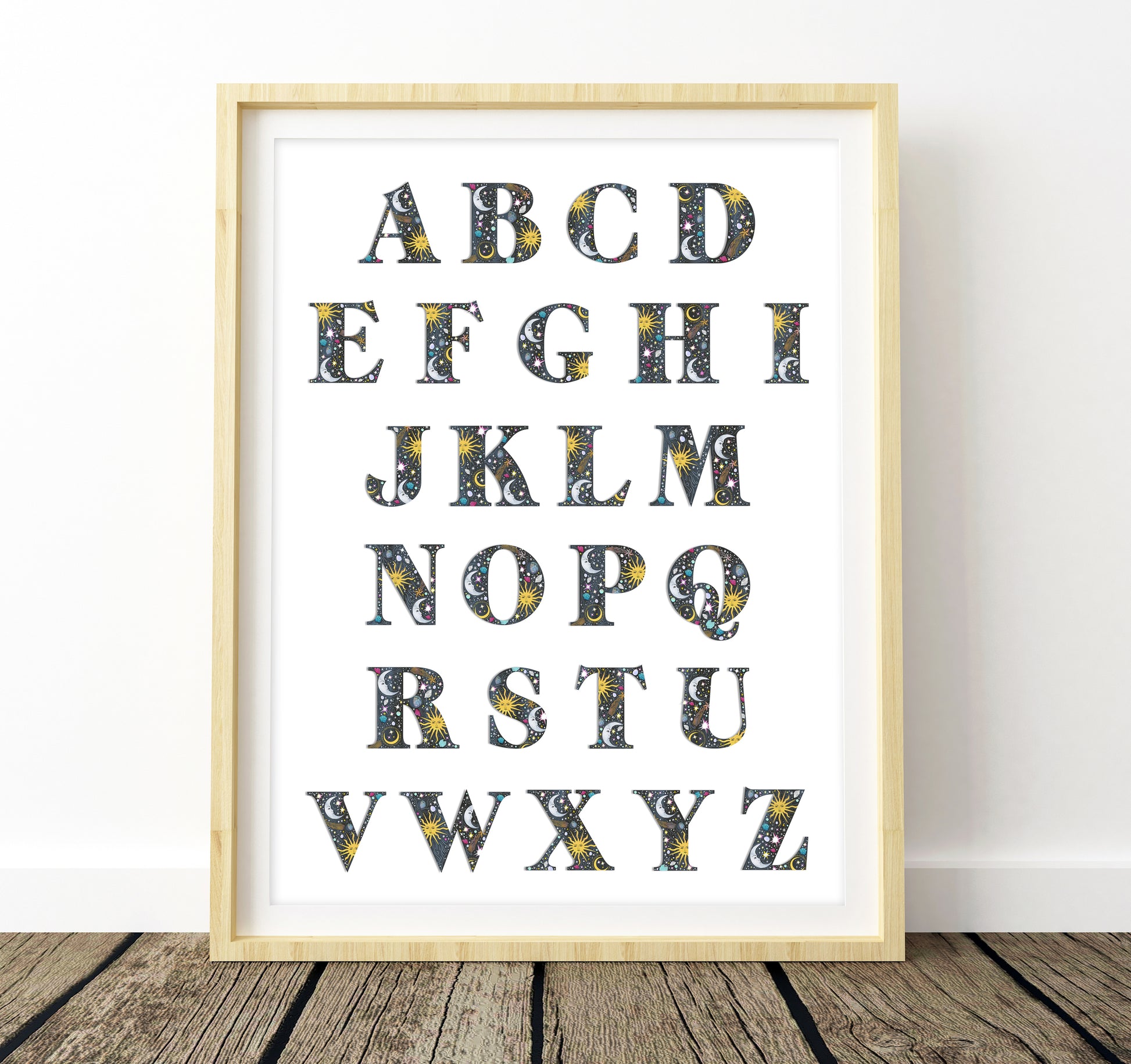 Framed alphabet poster with decorative letters on a white background