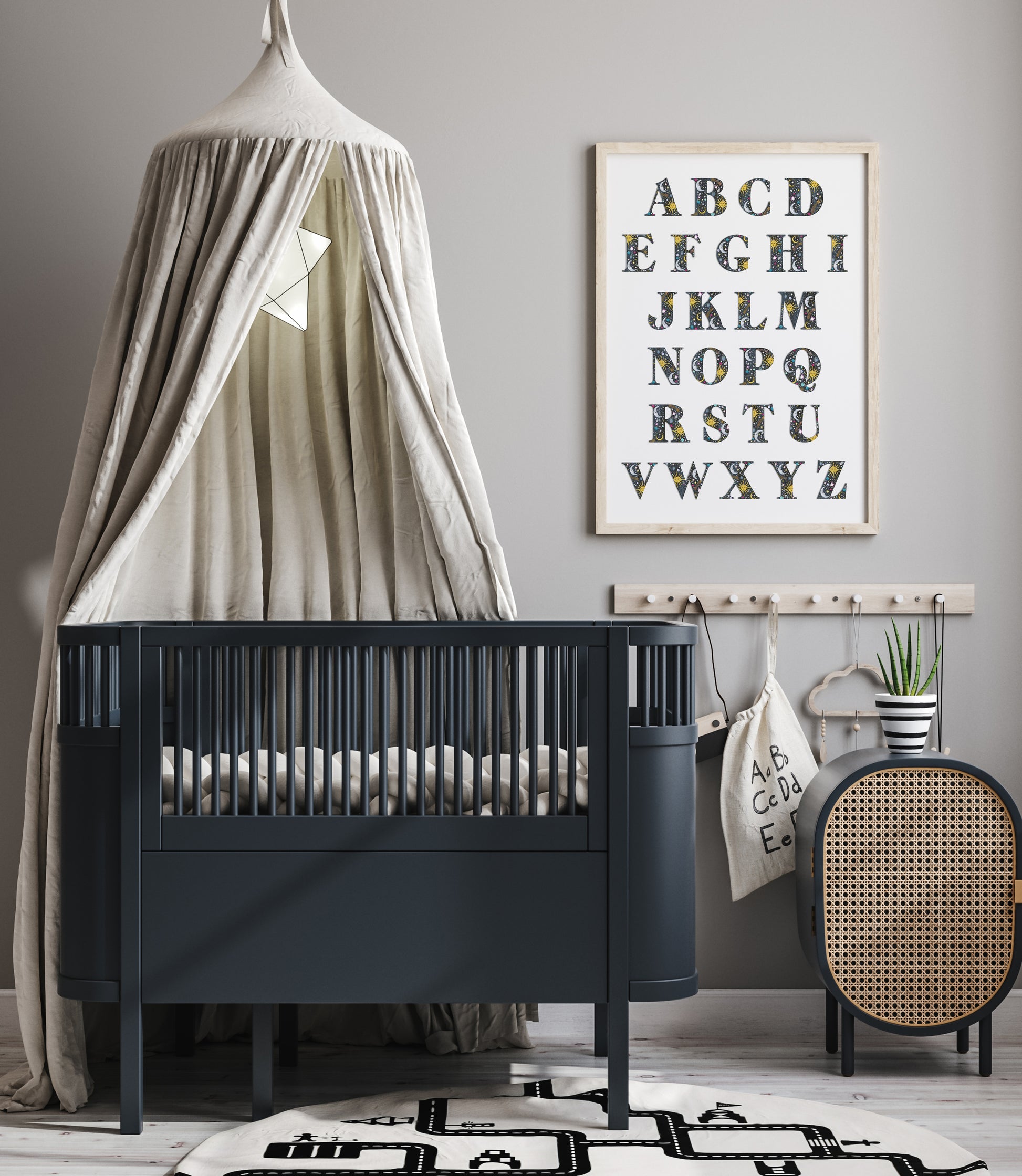 Nursery room with a black crib, decorative canopy, and alphabet poster on a gray wall.