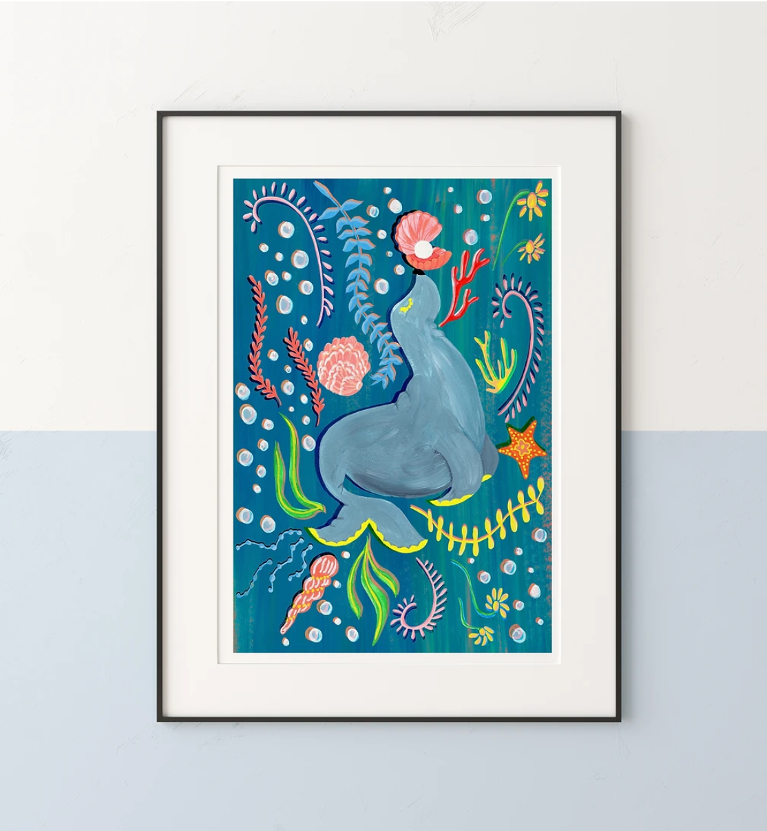 Framed artwork of a blue seal lion surrounded by sea plants on a blue background