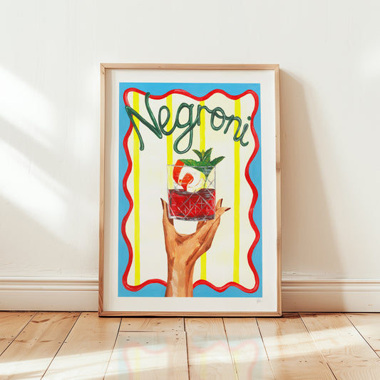 Framed artwork of a hand holding a Negroni cocktail against a colorful background.