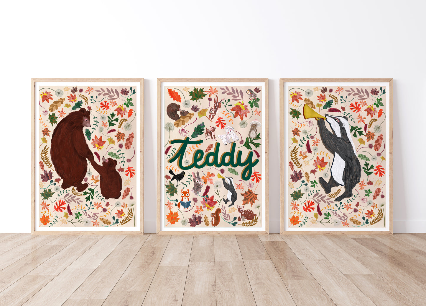 Three framed artworks with woodland animal illustrations and a woodland name print design on a white wall.