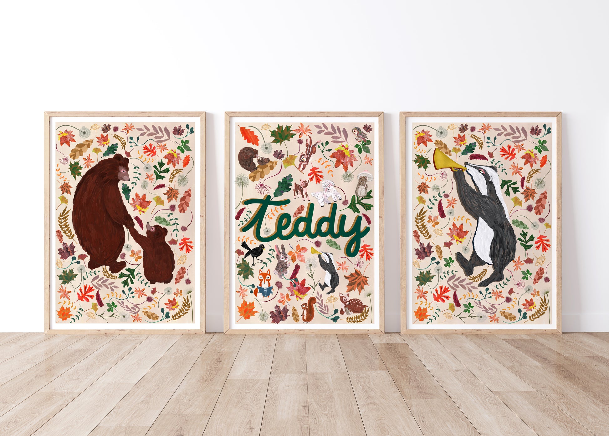 Three framed artworks with woodland animal illustrations and a woodland name print design on a white wall.
