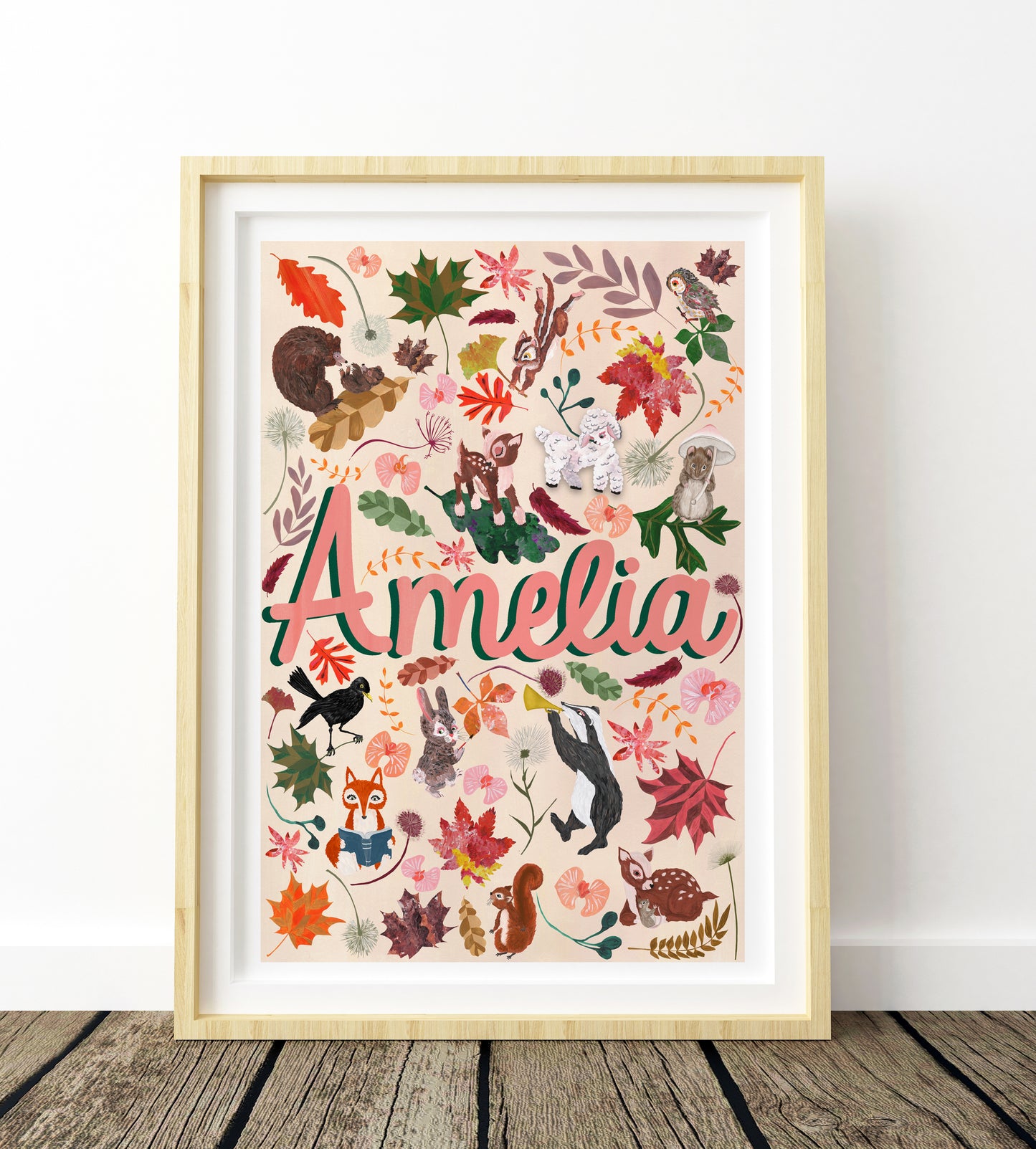 Framed artwork with 'Amelia' and nature-themed illustrations on a white wall.