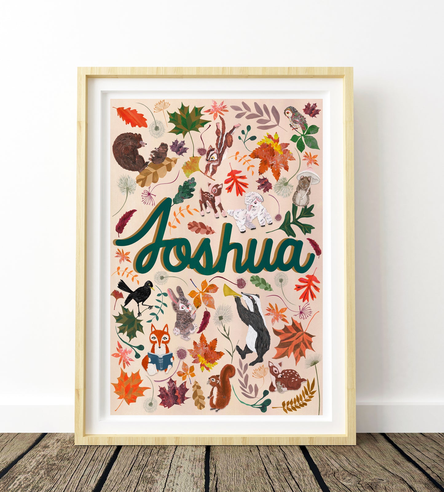Framed artwork with 'Joshua' and nature-themed illustrations on a white wall.