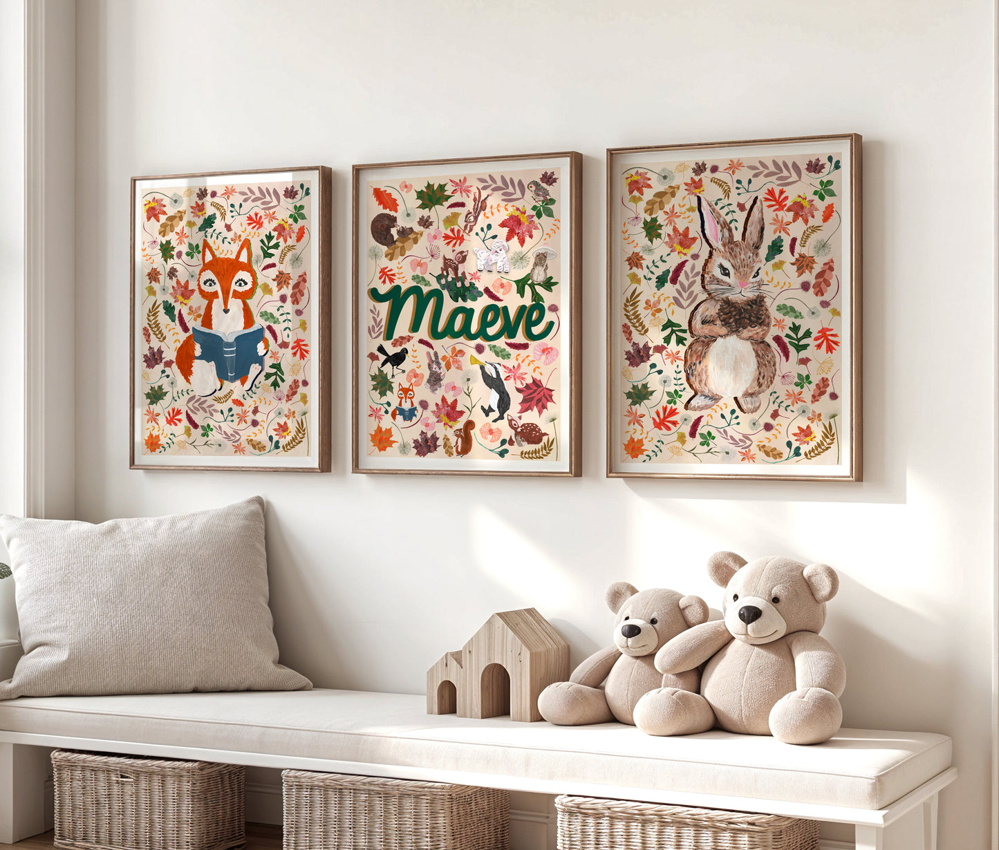 Three framed woodland animal-themed artworks above a bench with teddy bears and a wooden house.