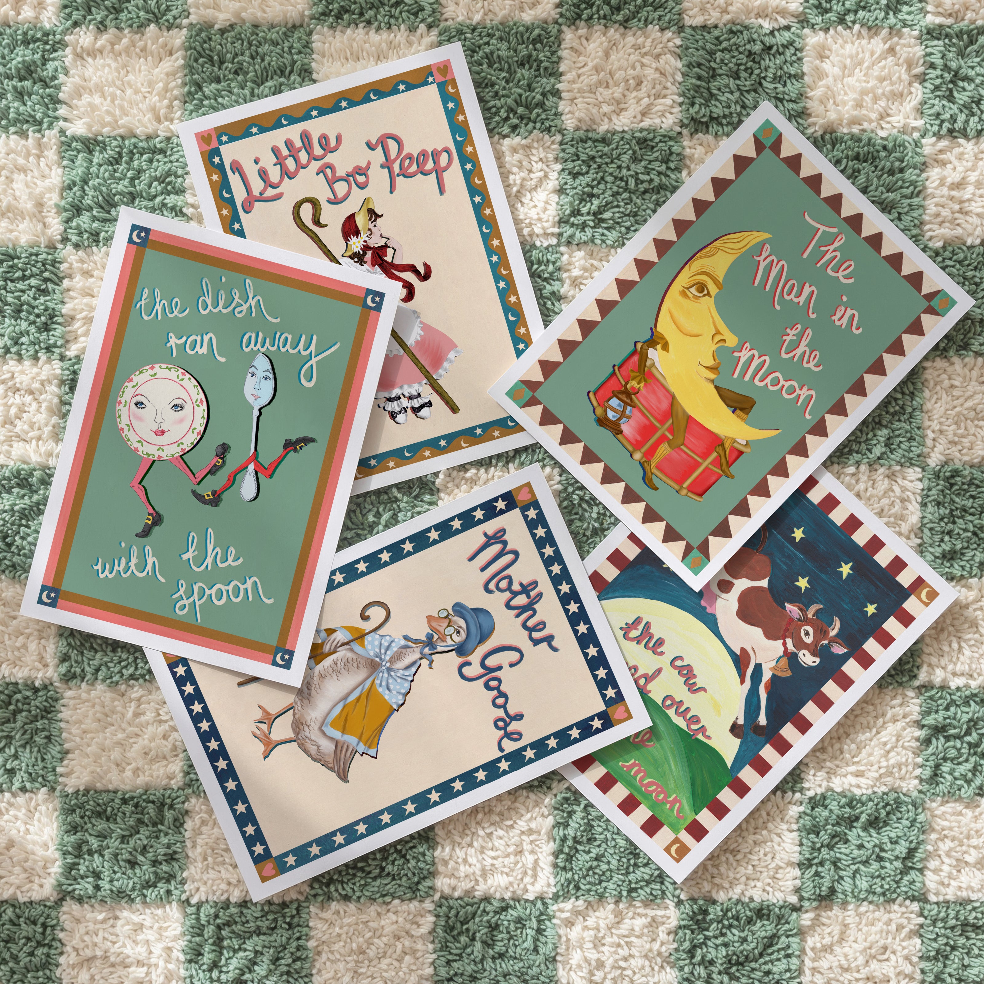 Collection of children's nursery rhyme cards on a checkered fabric background