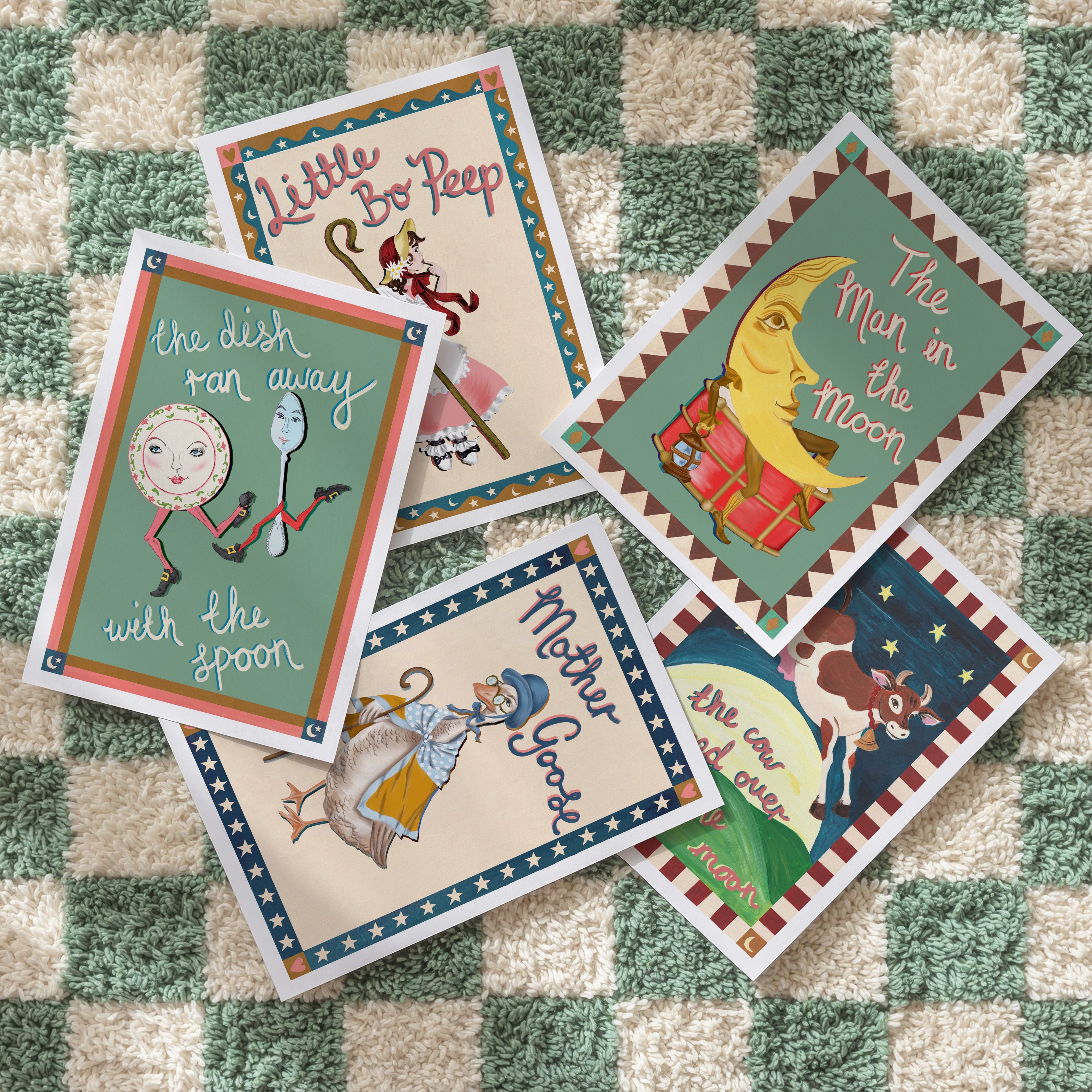 Collection of children's nursery rhyme cards on a checkered fabric background