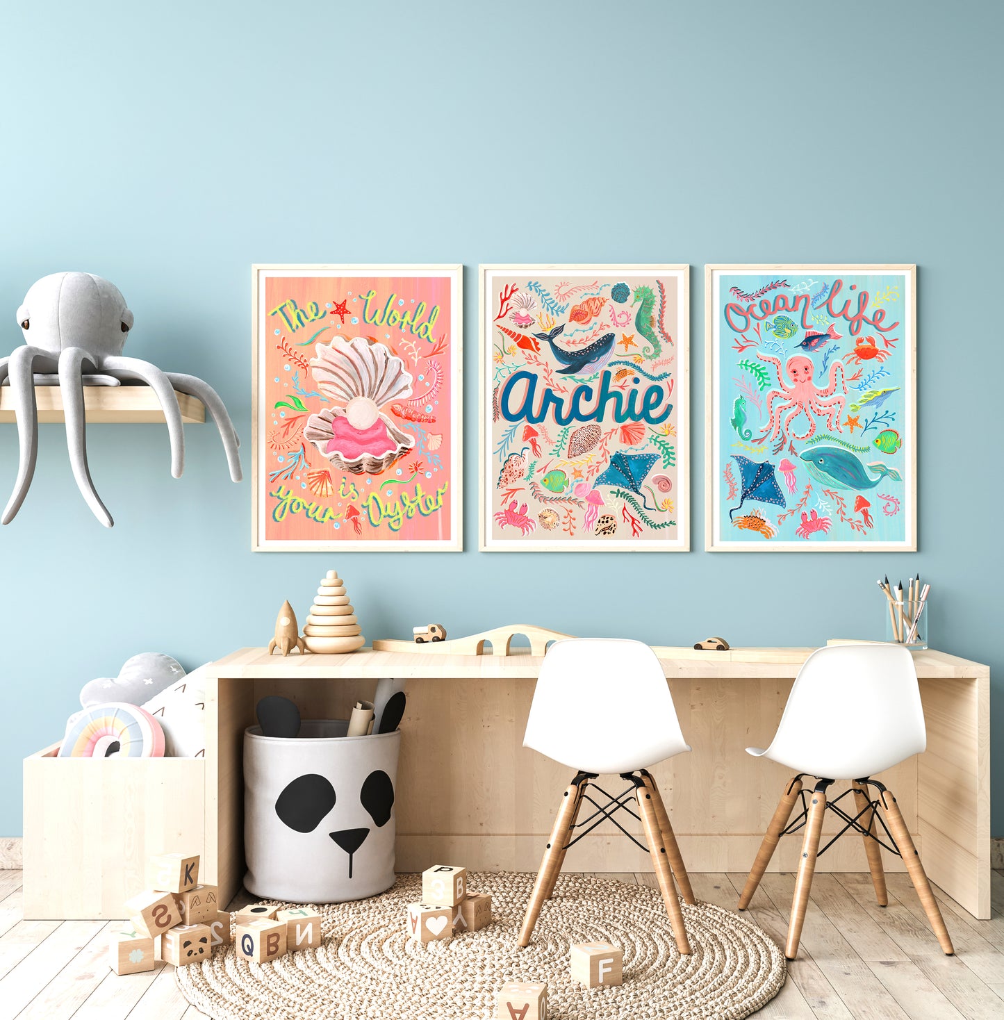 Children's room with colorful wall art, toys, and furniture against a light blue wall.
