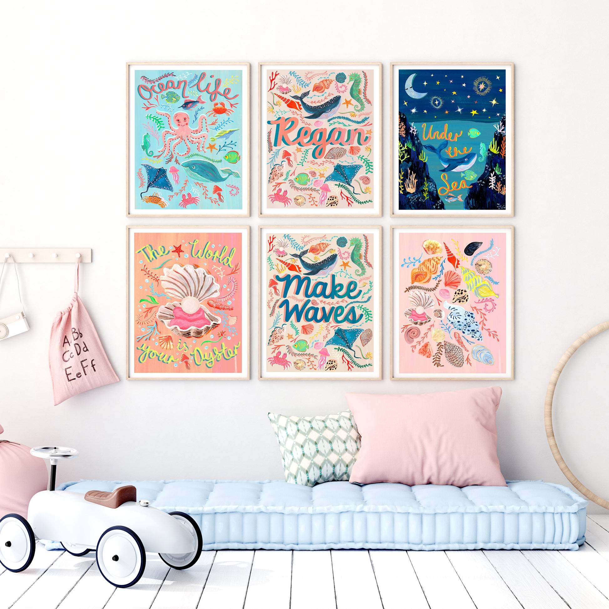 Colorful children's wall art prints on a wall above a bench.