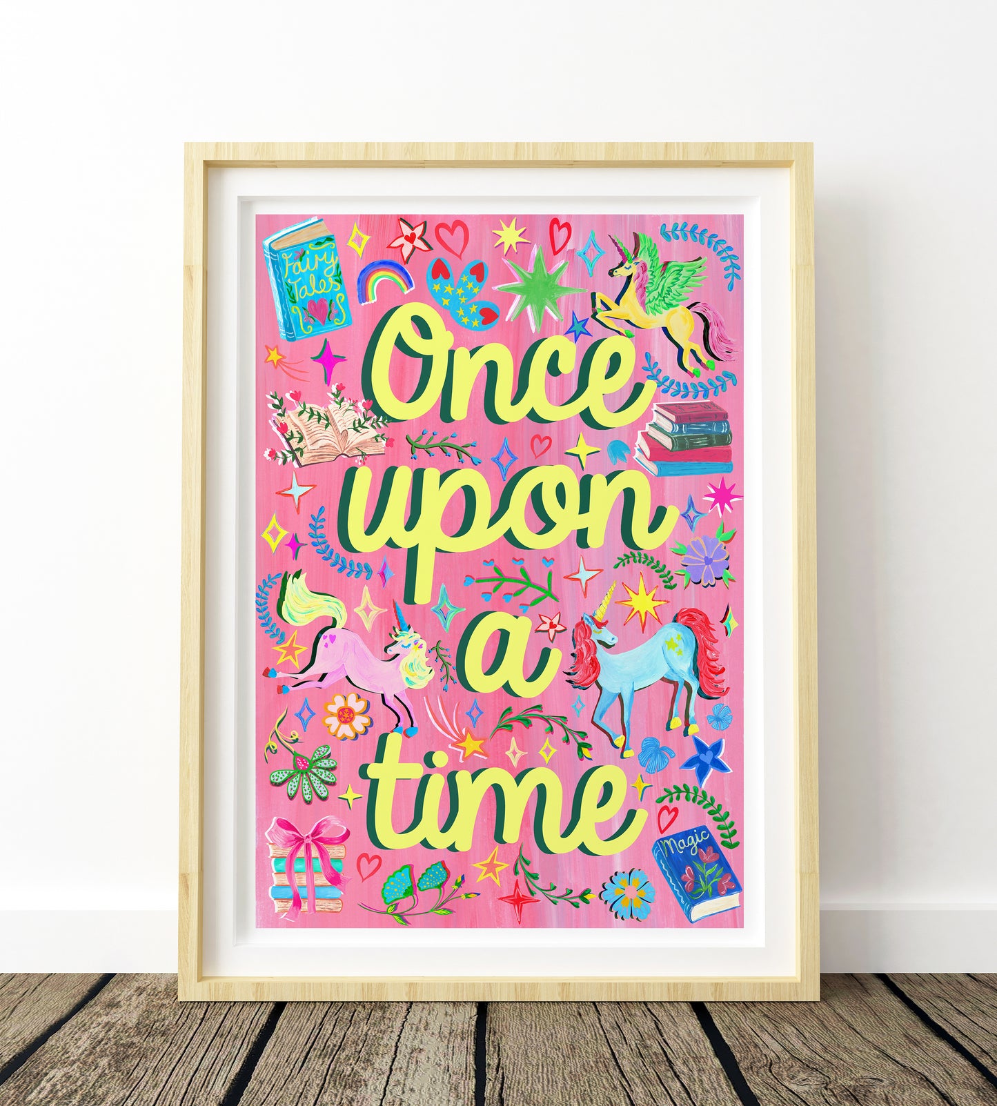 Framed artwork with 'Once upon a time' text and colorful illustrations on a pink background.