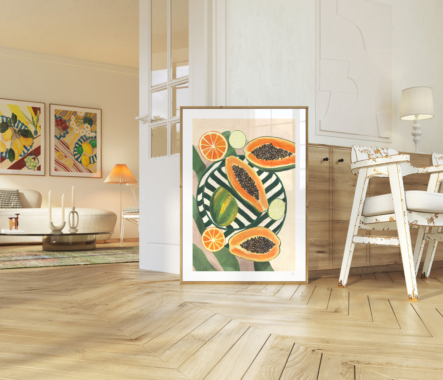Framed artwork of papaya and oranges in a modern living room.