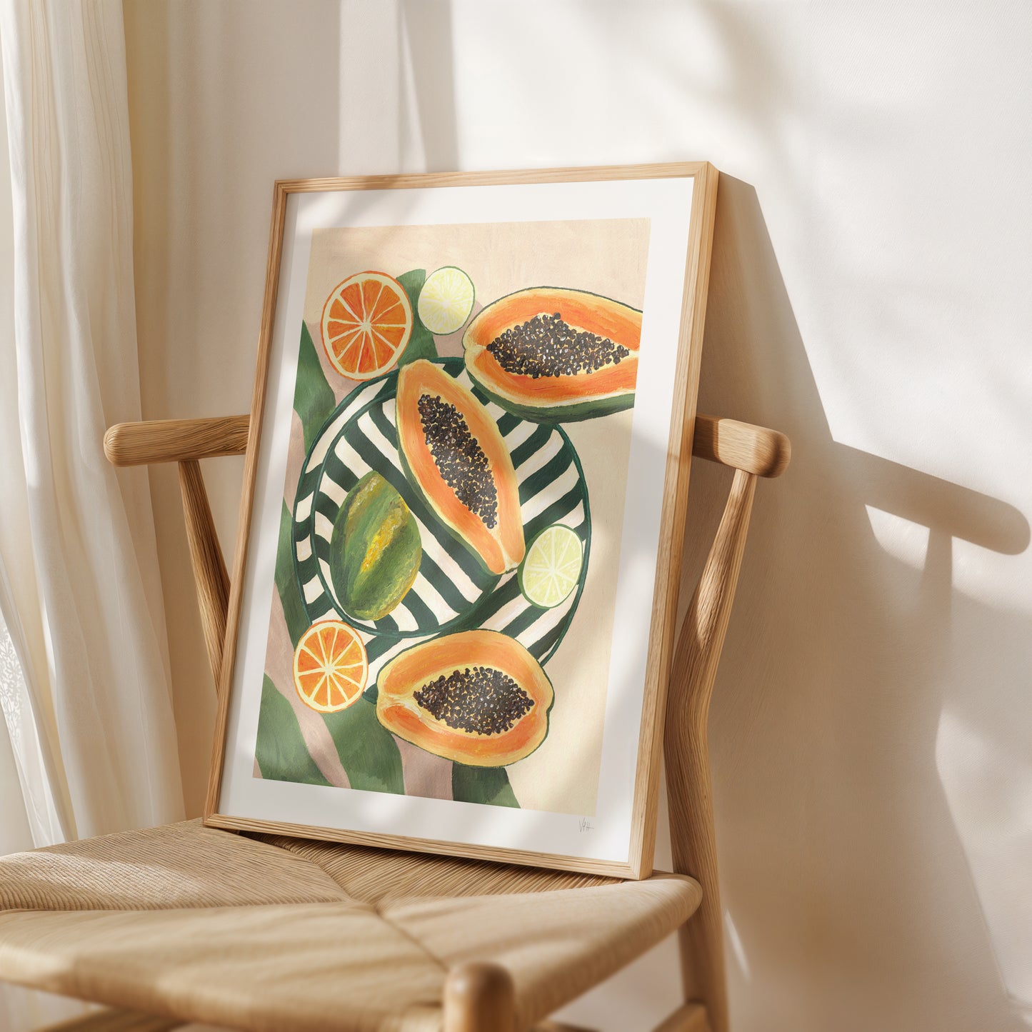 Framed artwork of papayas and oranges on a wooden chair with a white curtain background