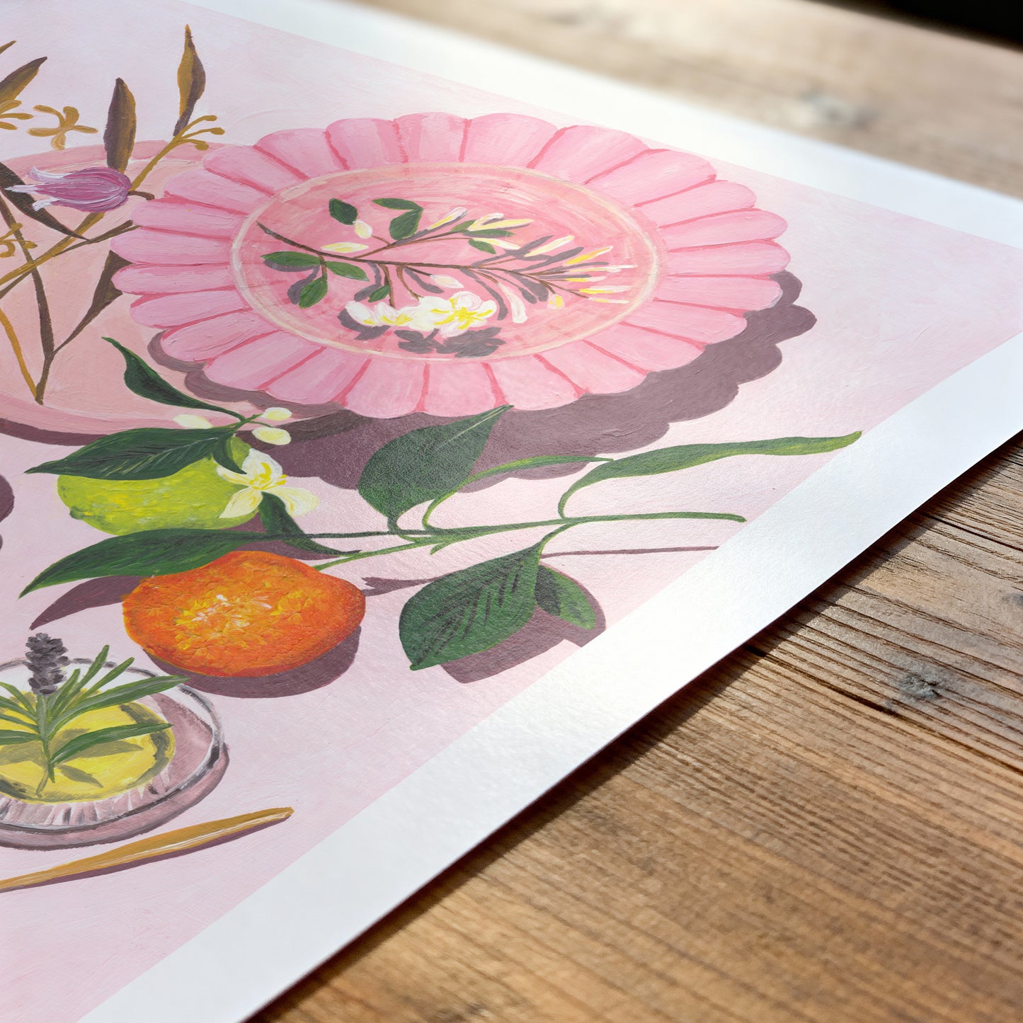 Illustration of a pink flower and orange on a wooden surface