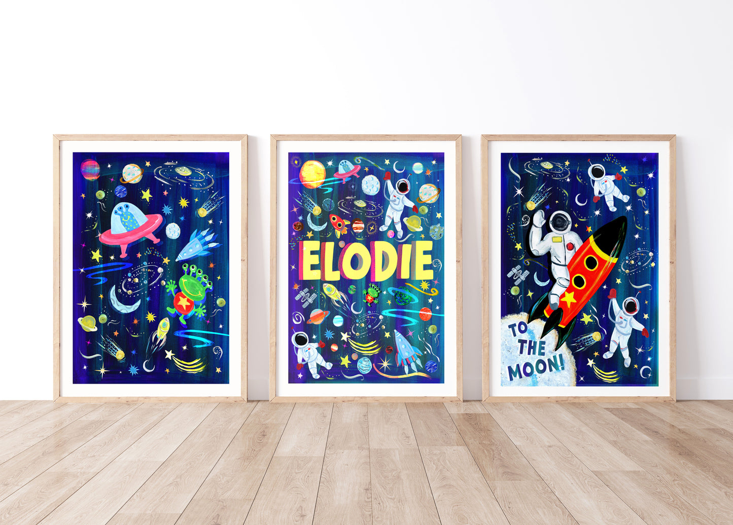Three colorful space-themed posters with 'Elodie' on a white wall.