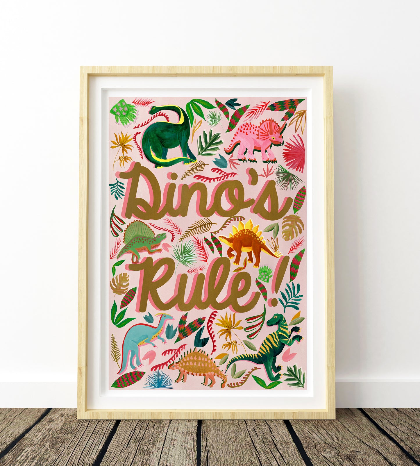 Framed artwork with colorful dinosaurs and 'Dino's Rule!' text on a white background