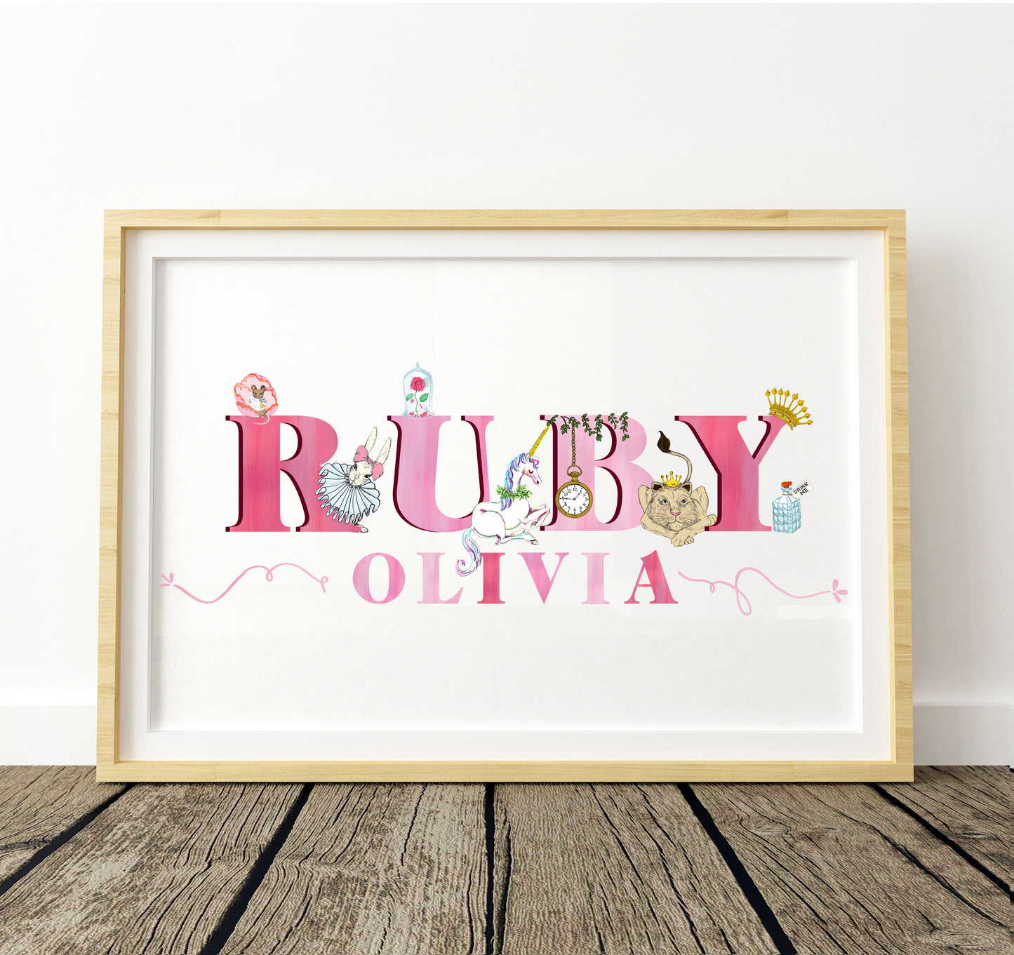 Framed artwork with 'RUBY OLIVIA' in fairytale illustration decorative letters on a white background