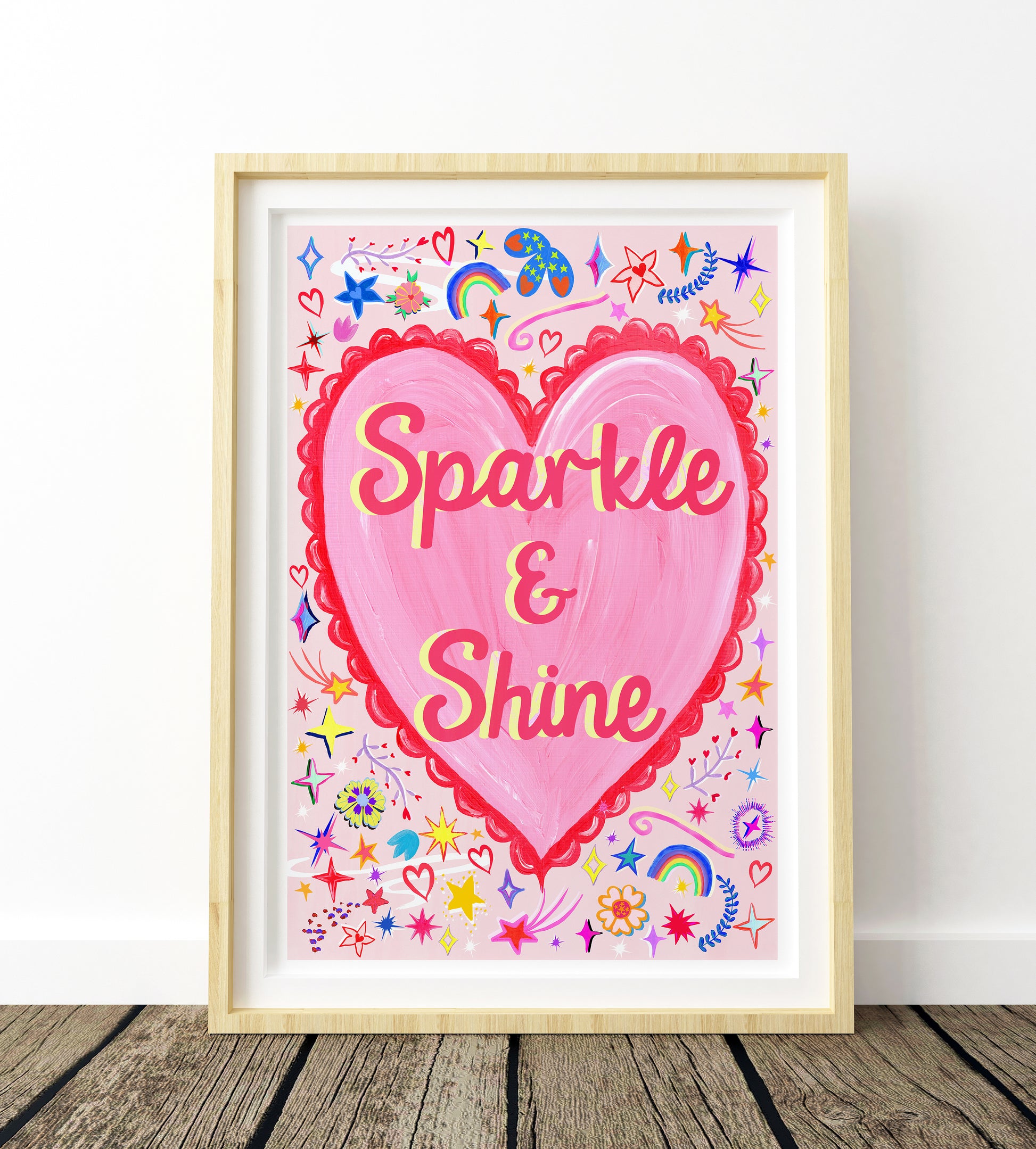 Framed artwork with a pink heart and 'Sparkle & Shine' text on a white background.