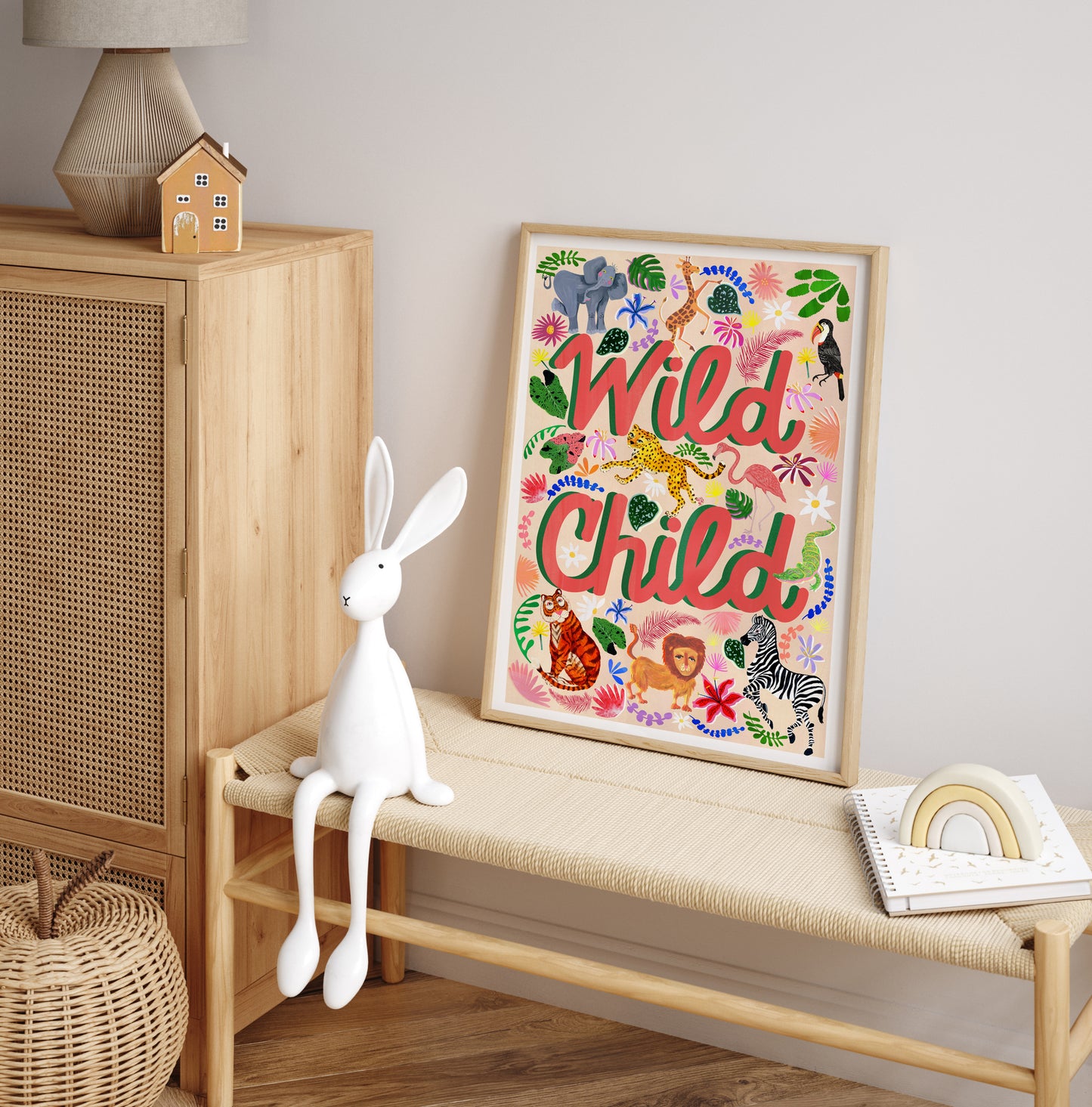 Framed artwork with 'Wild Child' text on a wall next to a wooden cabinet and bench.