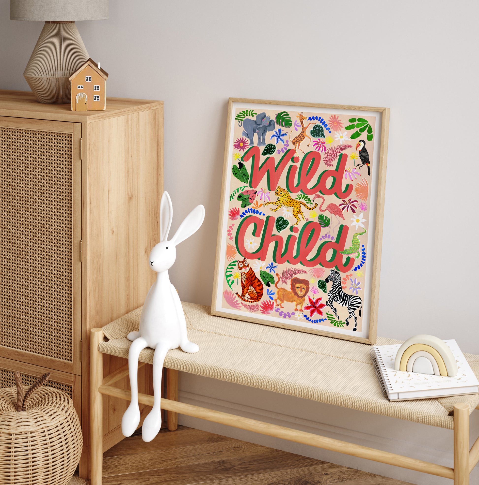 Framed artwork with 'Wild Child' text on a wall next to a wooden cabinet and bench.