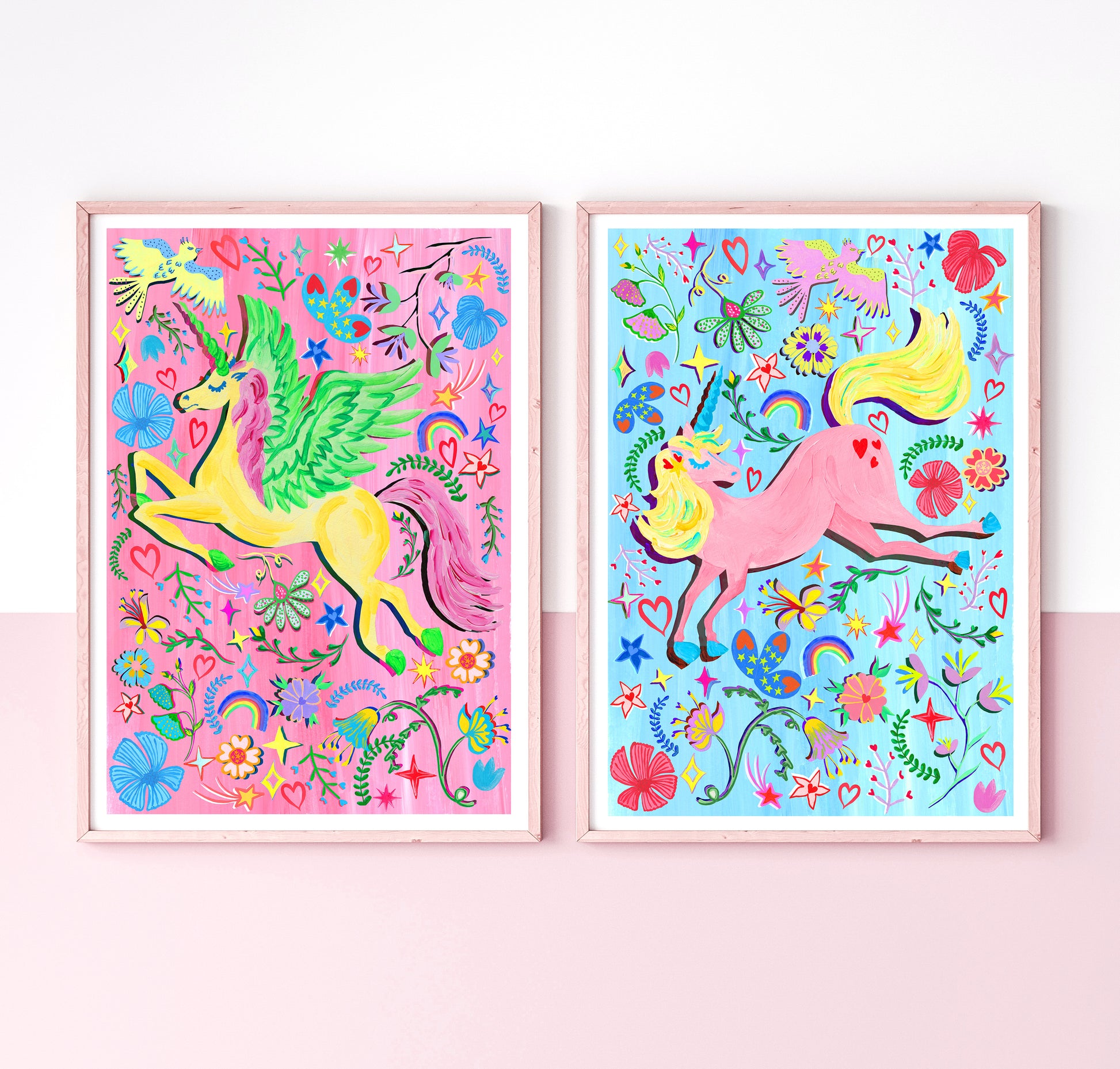 Two colorful unicorn illustrations in frames on a pink background