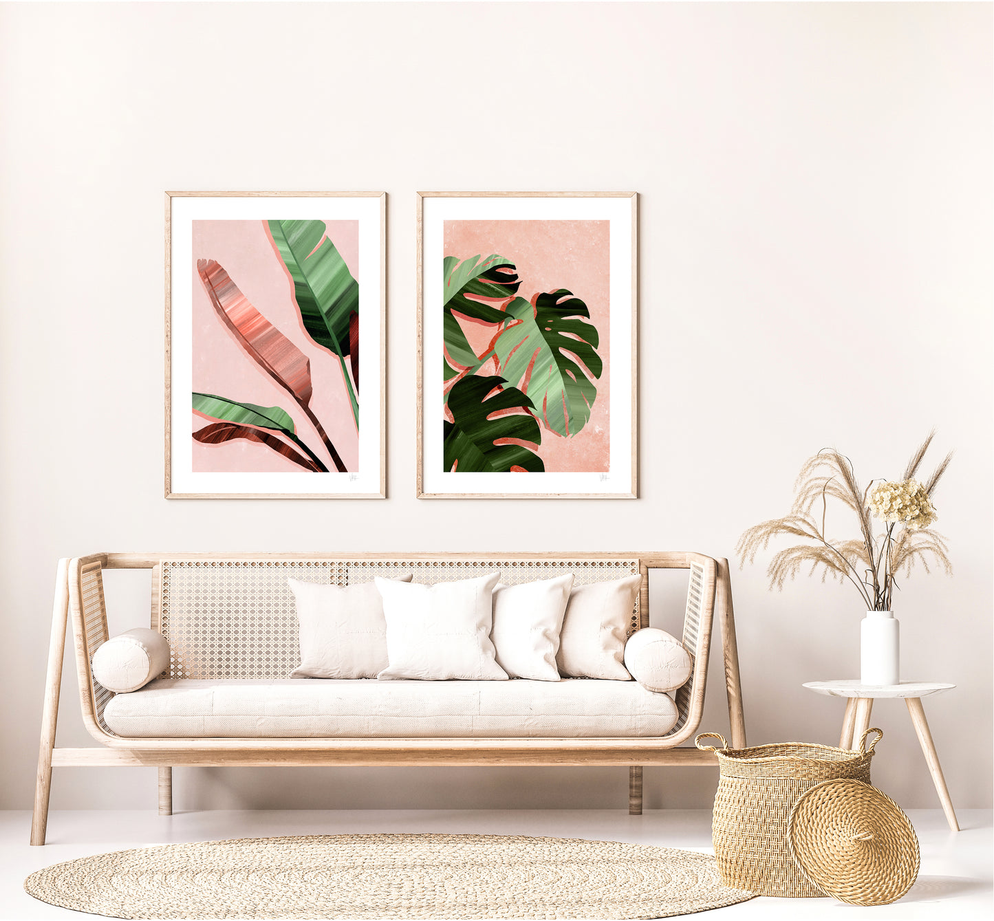 Living room with a wicker sofa, decorative pillows, and framed leaf prints on the wall.