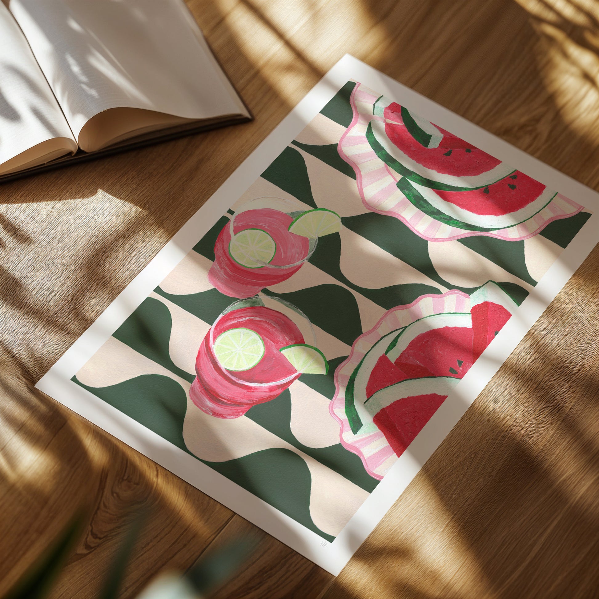 Framed artwork with watermelon and flower pattern on a wooden surface